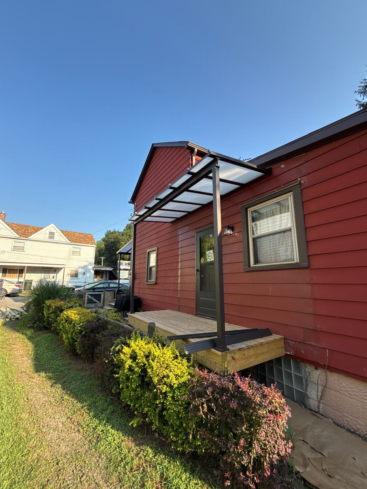 Roof sunspace deck  by Cousins Roofing Siding & Decks