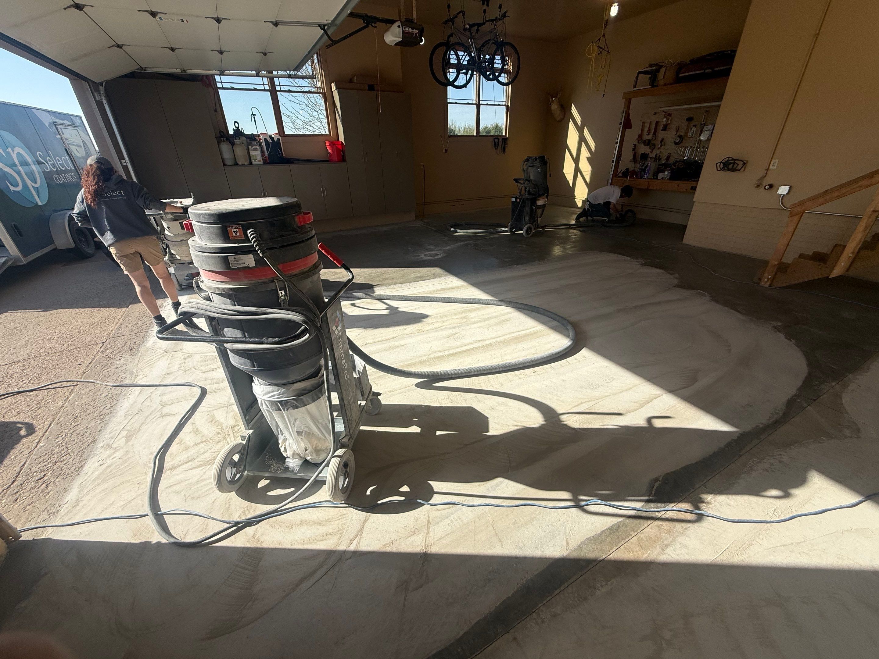 Residential Garage Floor Transformation with Speckled Epoxy Coating by Select Painting, Coatings & Garage Cabinets