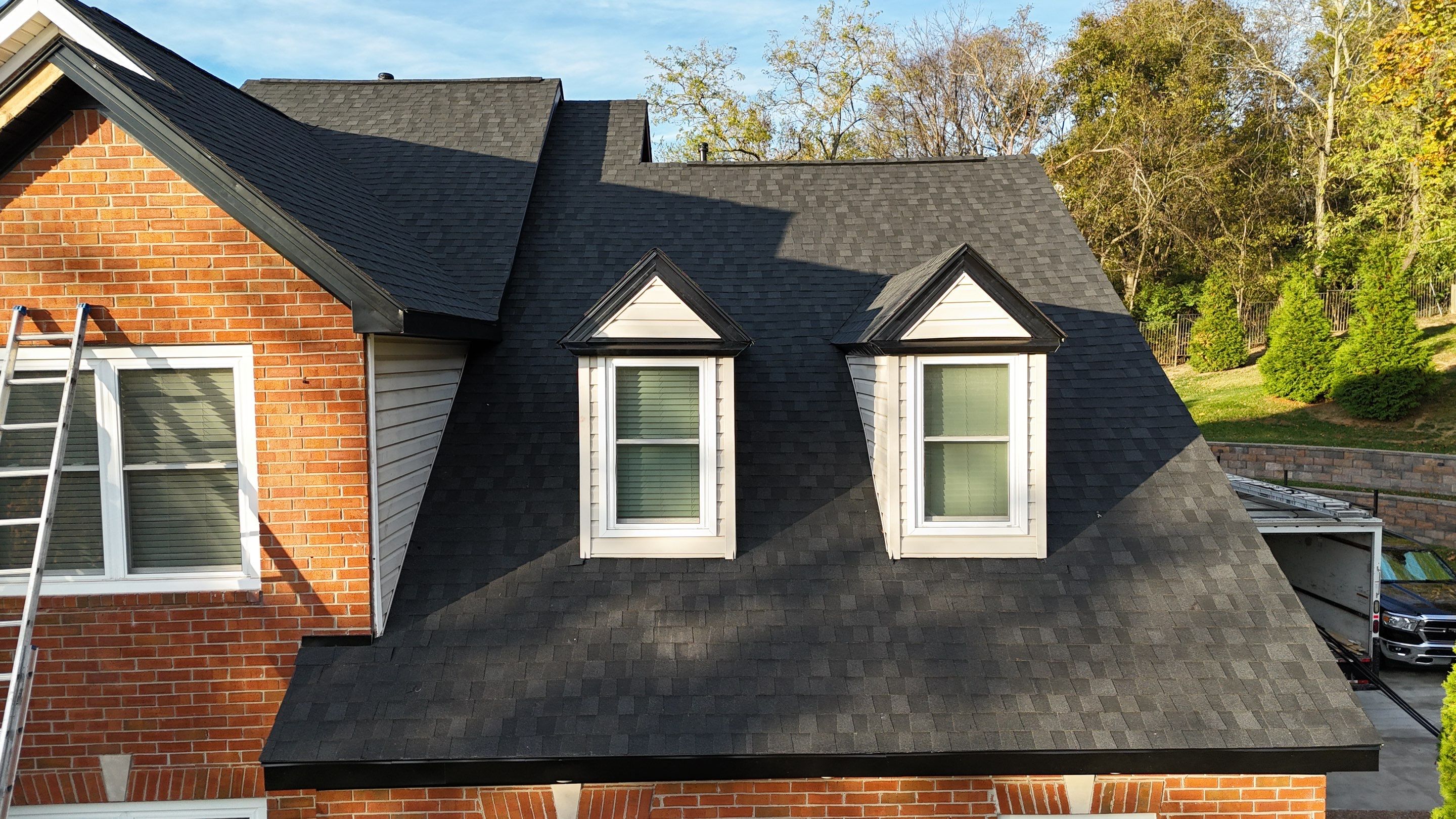 Charcoal Black Re-Roof & Gutters by Royal House LLC