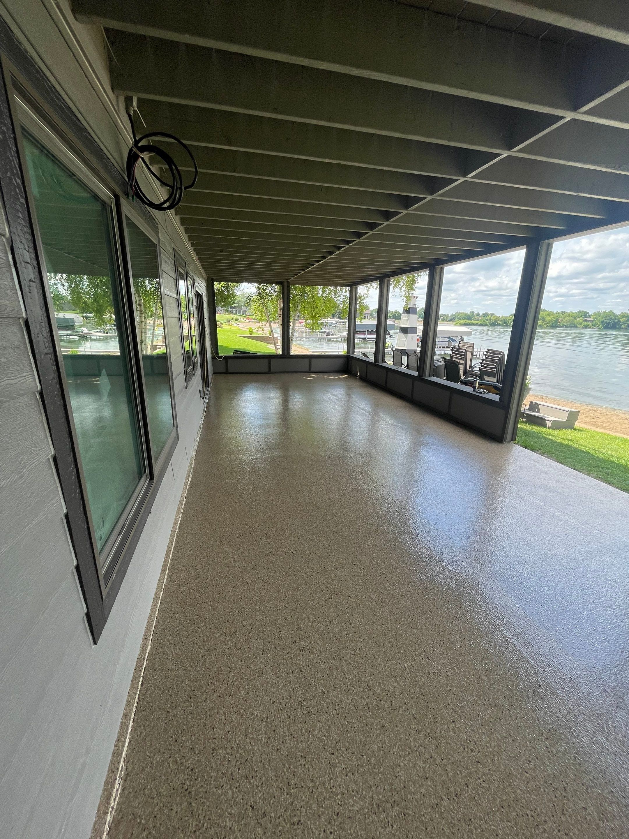 Lakefront Screened Patio Concrete Coating Installation in Wentworth by Select Painting, Coatings & Garage Cabinets