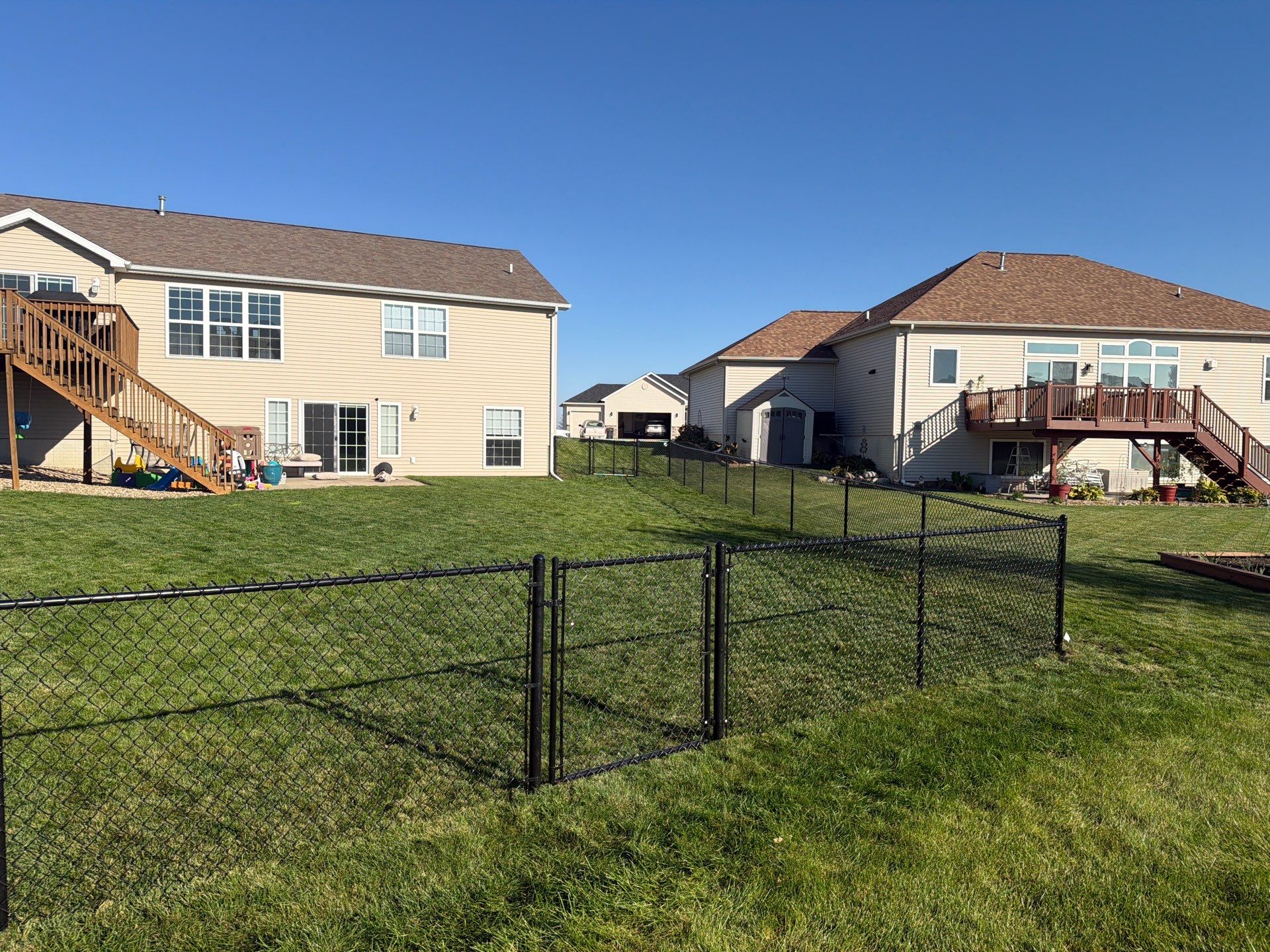Black Vinyl-Coated Chain Link Fence Installation in Cedar Falls by Perfect Picket Fence and Stain