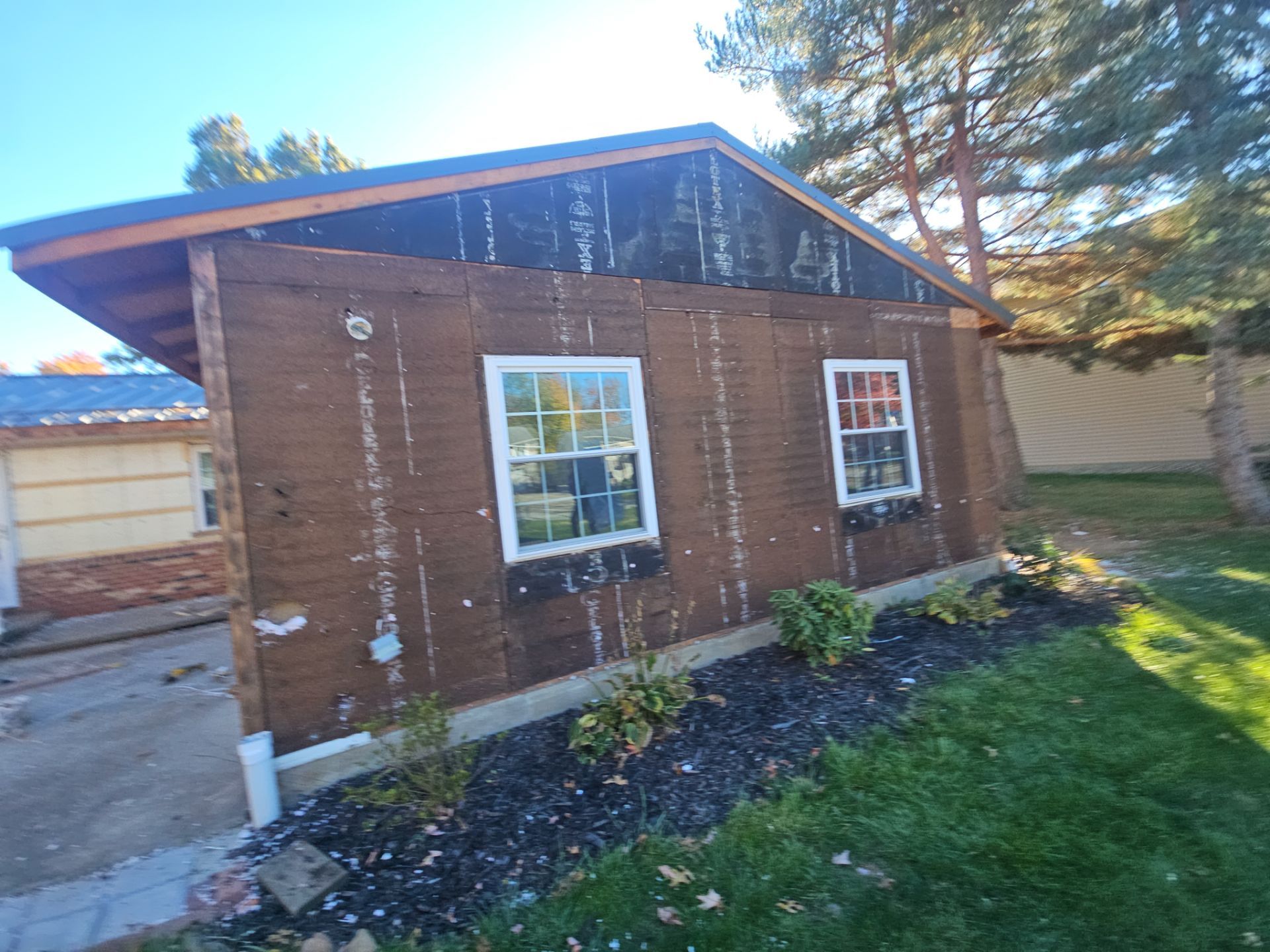 Wadsworth Exterior Transformation Featuring Blue Vertical Siding and Metal Roofing by Cornerstone Roofing And Siding