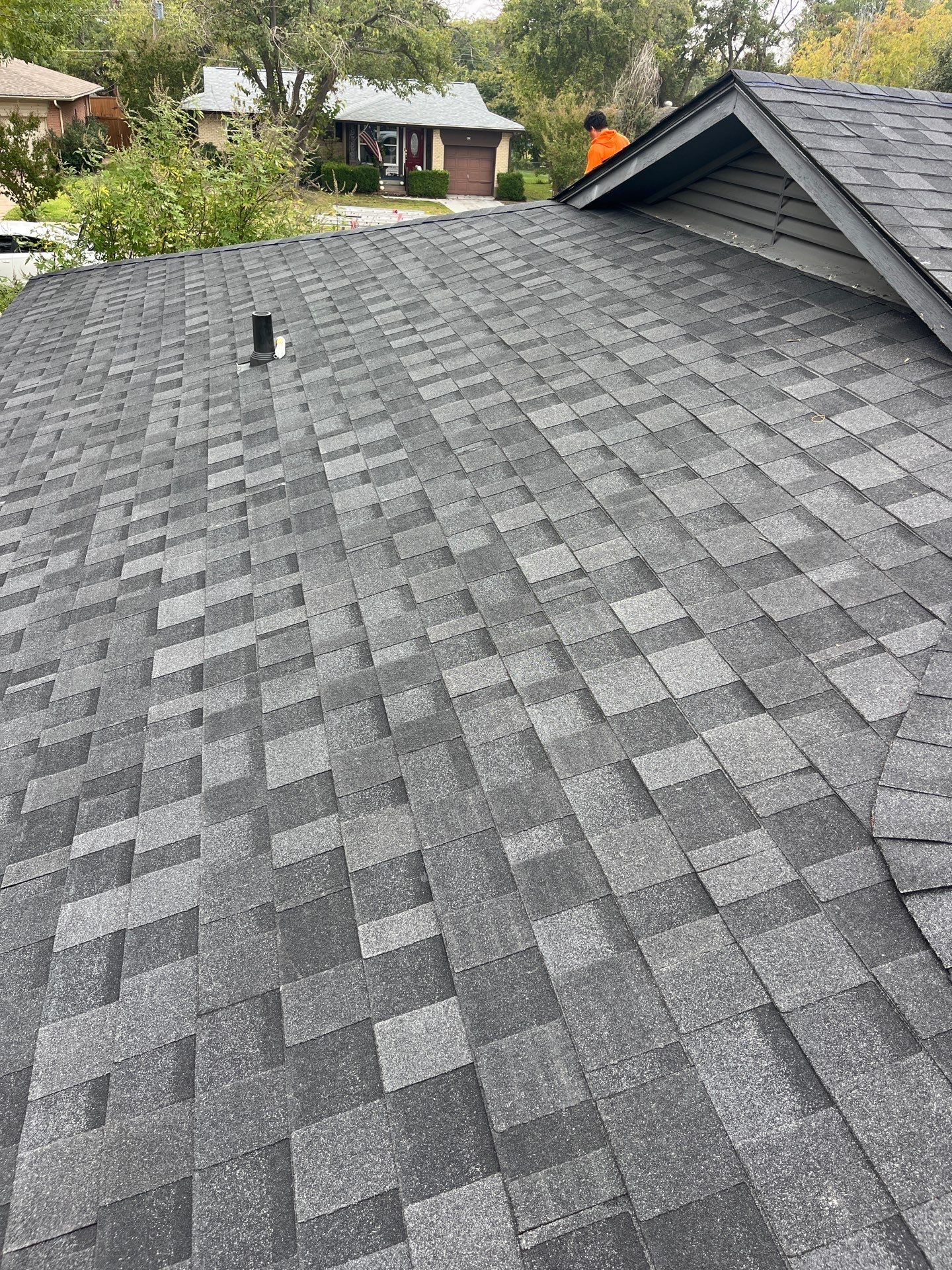 White brick/black accents with IKO Granite Black by Tejas Roofworks + Restoration