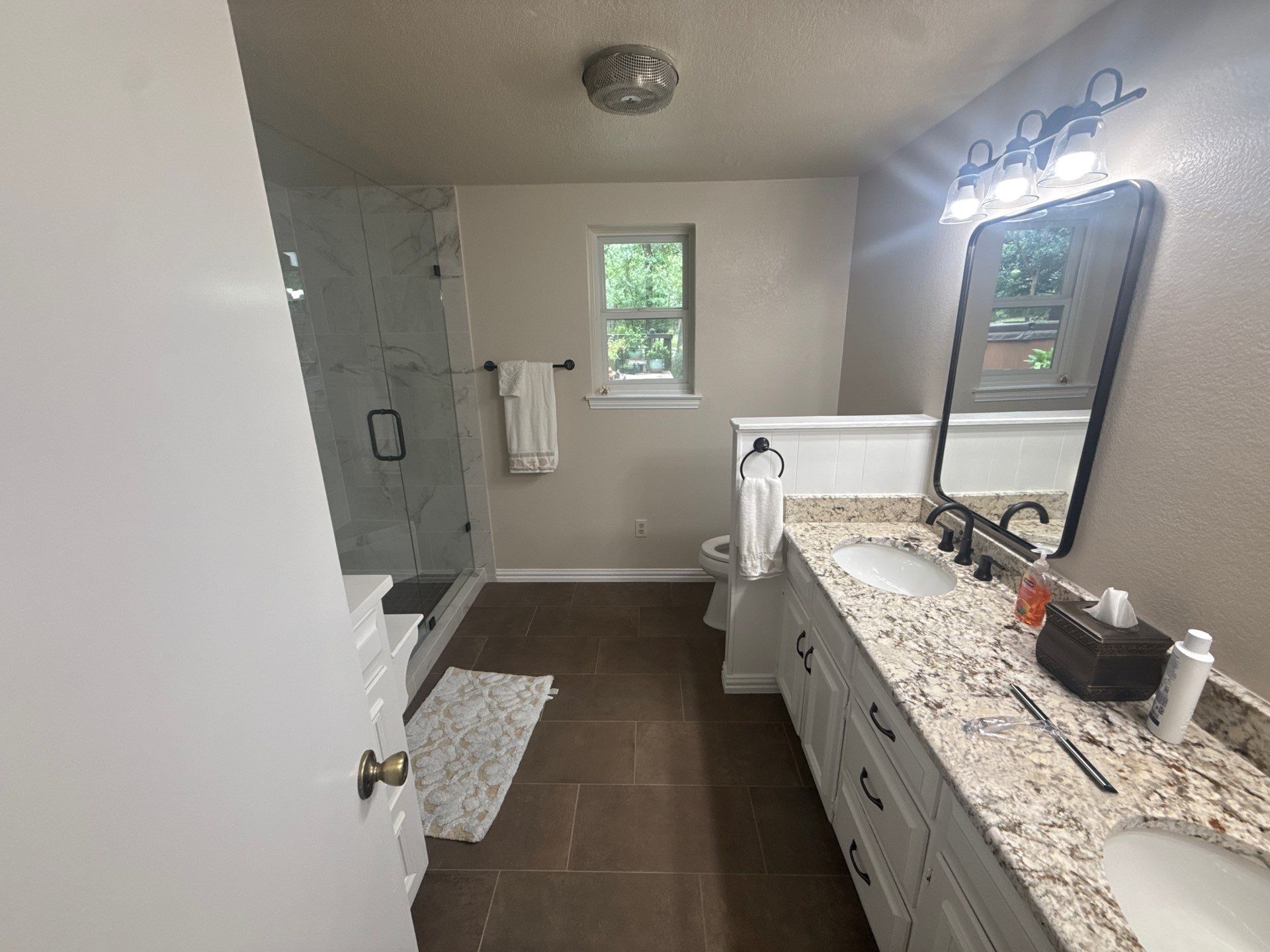 Bathroom Remodel with Marble Tile and Granite Vanities in Argyle by Simmons Floors