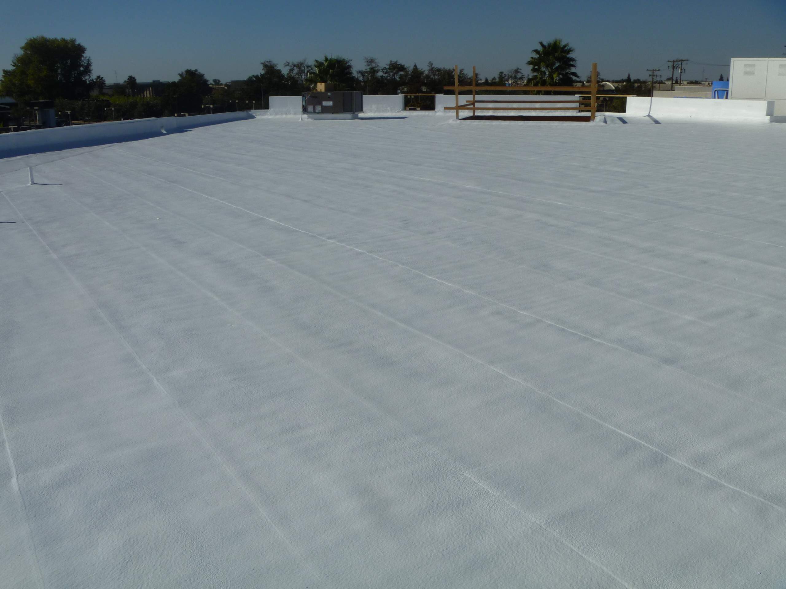 Commercial Roofing Installation using Spray foam and Conklin Benchmark/PUMA XL 18 yr warranty coatings by Straight Edge Roofing Inc