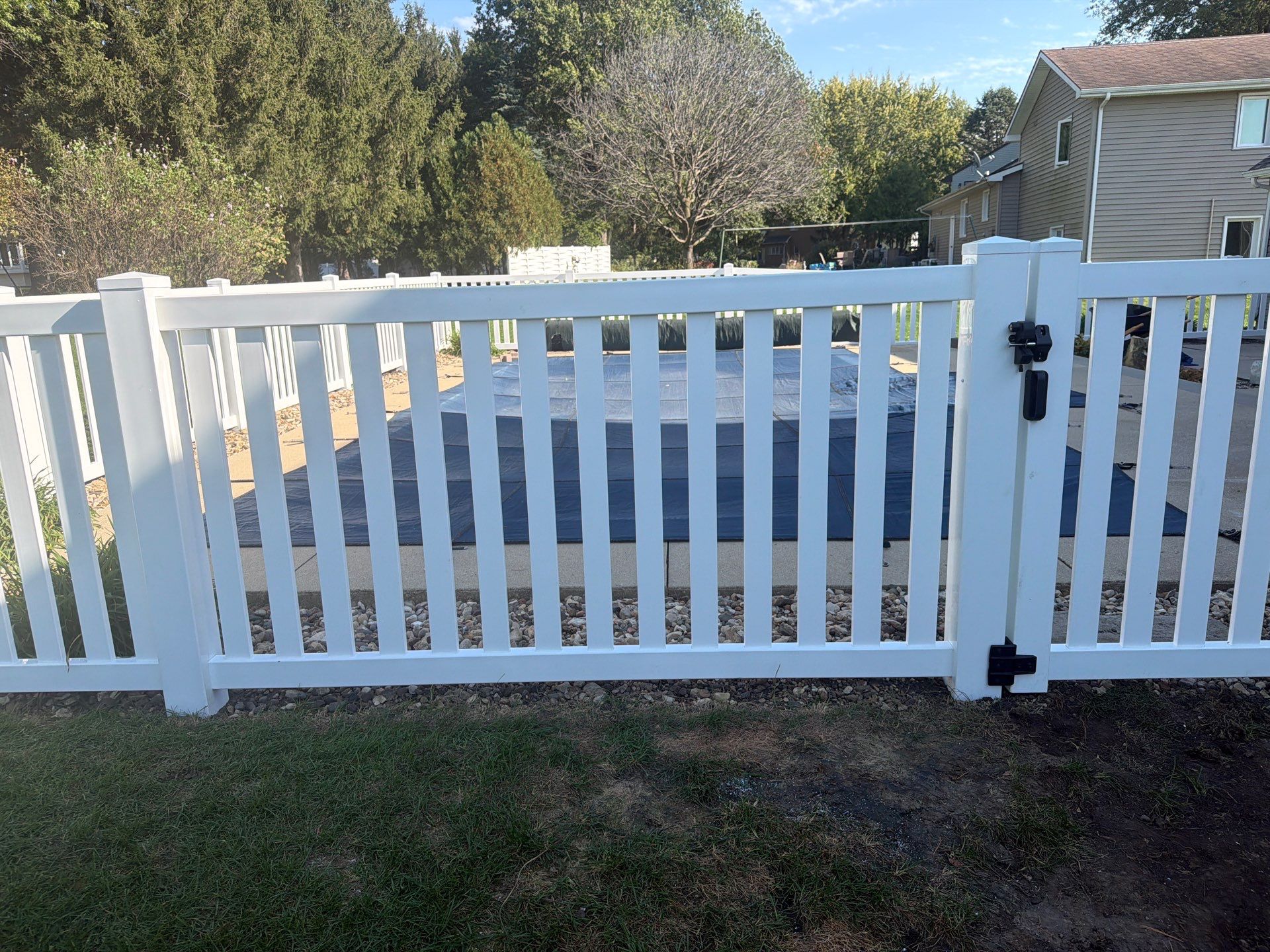 White Vinyl Picket Pool Fence Installation in Waterloo, Iowa by Perfect Picket Fence and Stain