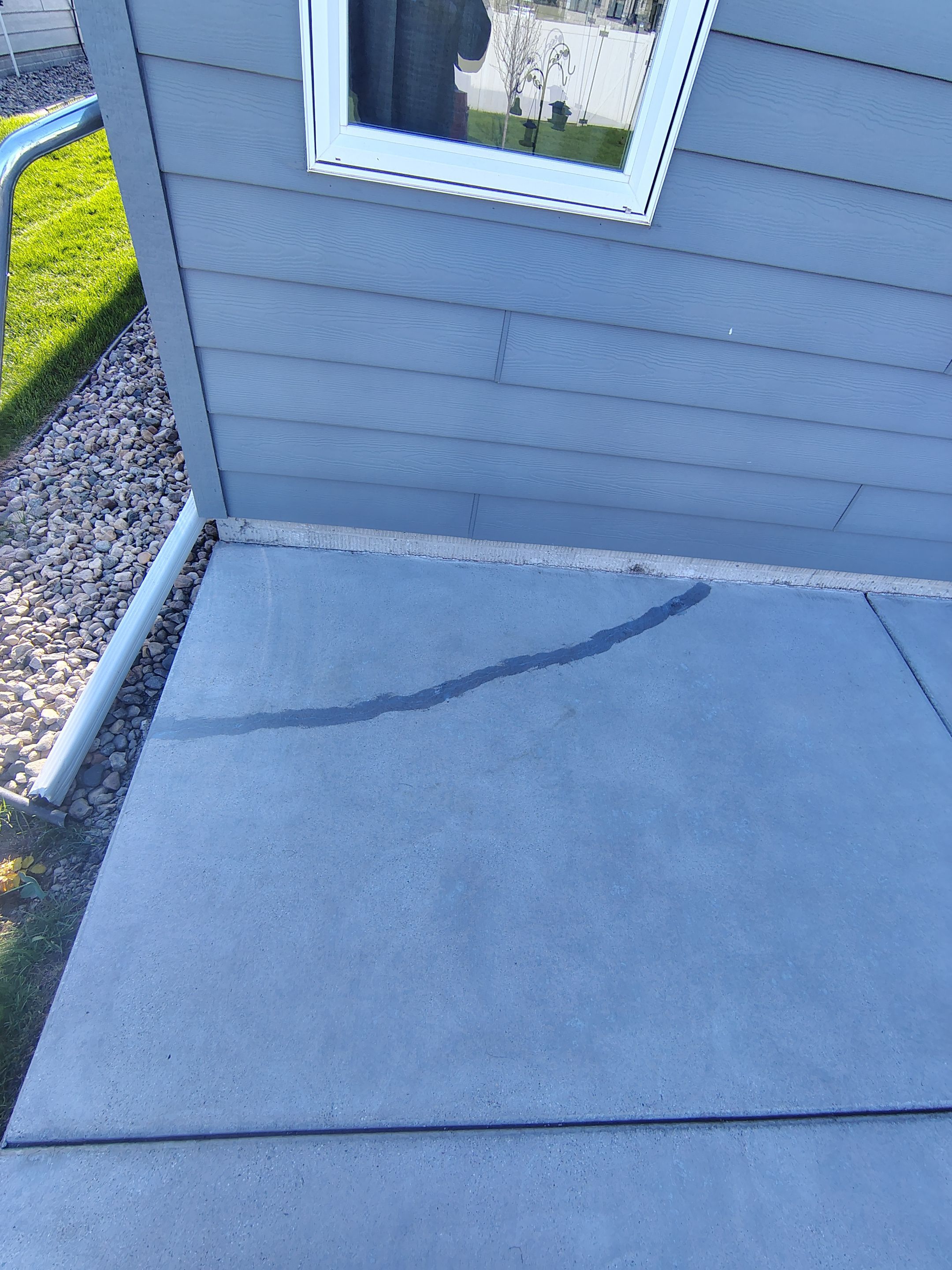 Speckled Concrete Patio Coating Installation in Sioux Falls by Select Painting, Coatings & Garage Cabinets