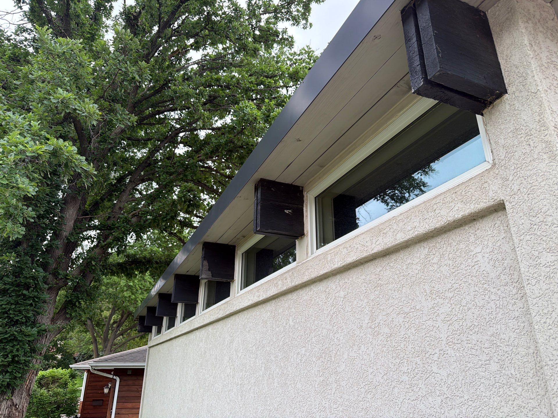 Exterior Trim Painting and Rafter Staining in Sioux Falls by Select Painting, Coatings & Garage Cabinets