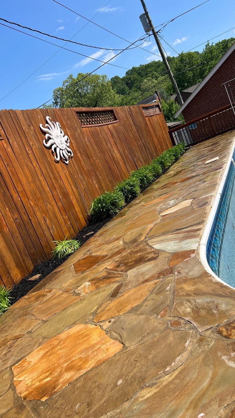Liriope grasses, mulch and stone pavers by GrassBusters, Inc.