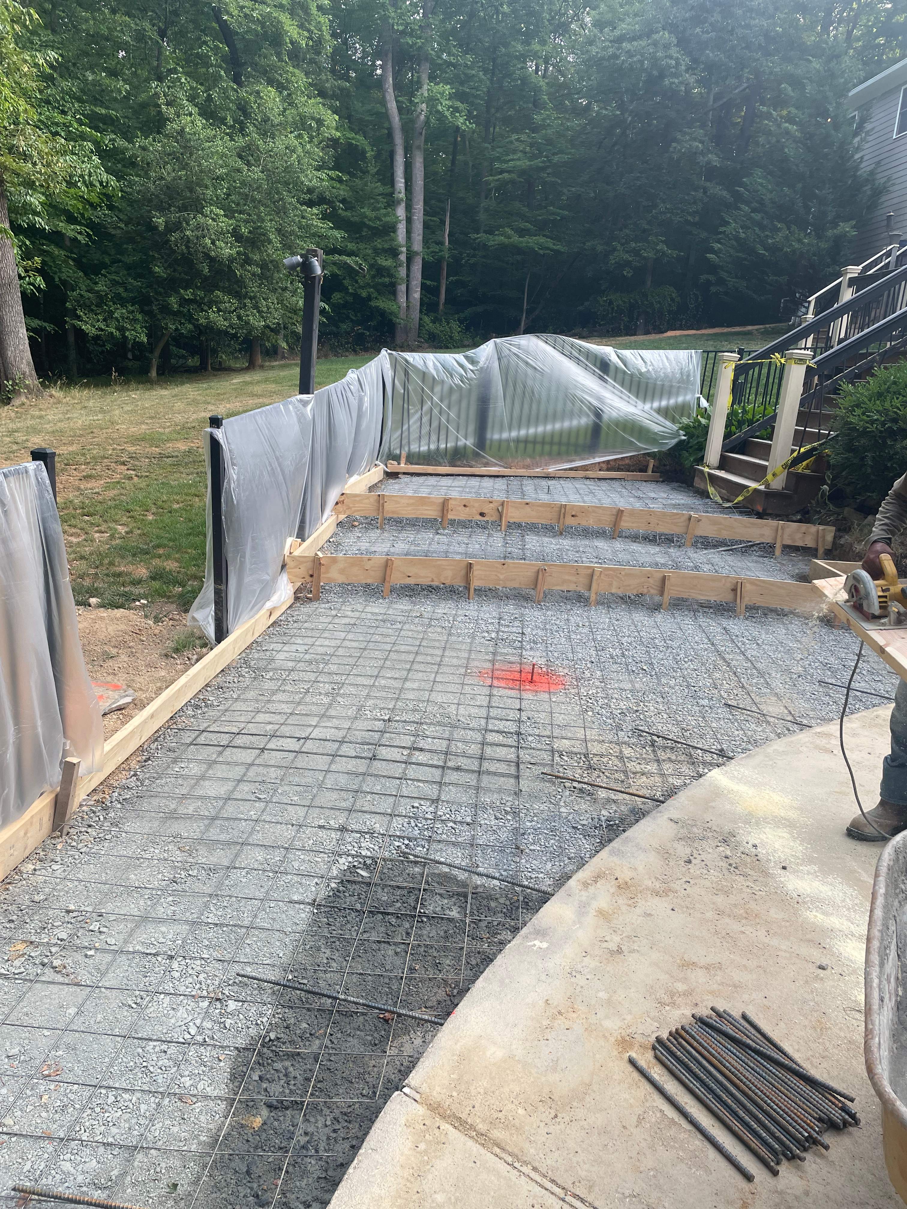 Pool Surround remodel with retaining walls, new waterfall and water slide by Fairfax Contractors, LLC