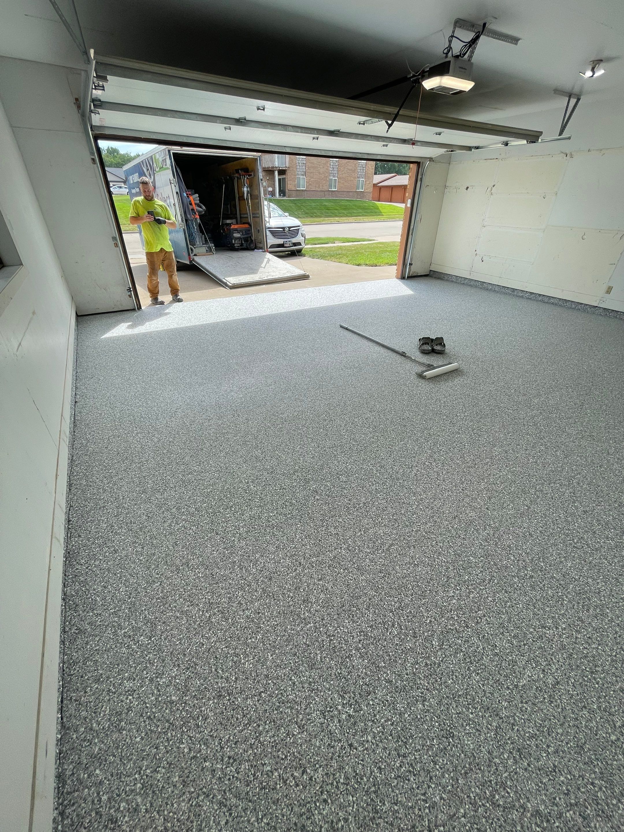 Grey Speckled Concrete Coating for Residential Garage in Yankton by Select Painting, Coatings & Garage Cabinets