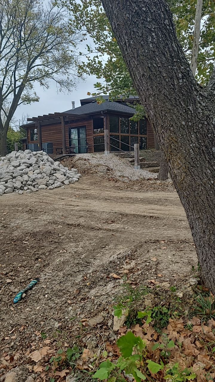 Supporting back of home with backfill at edge of steep creek by LAND ESCAPES LLC