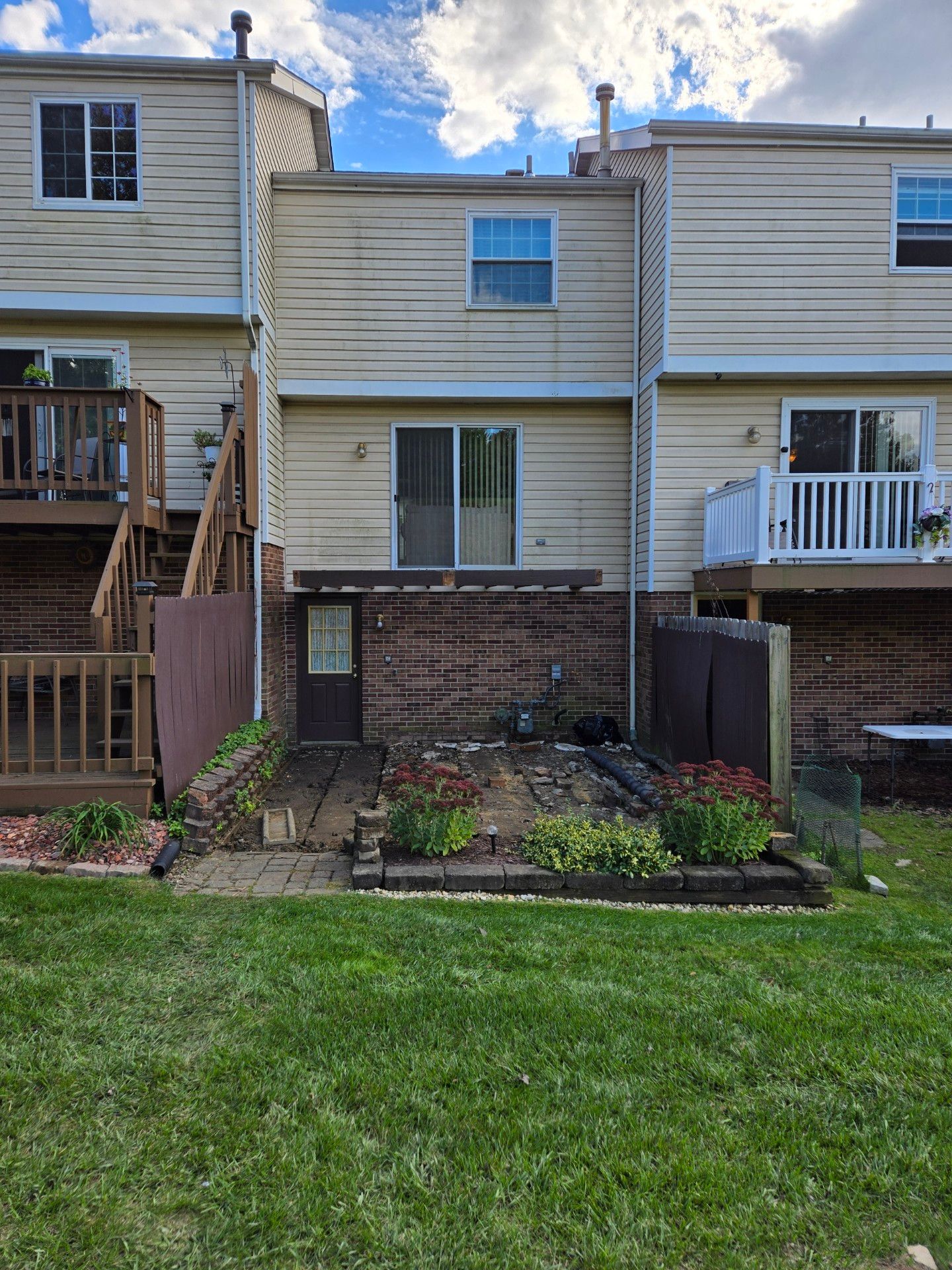 Stamped concrete and redeck  by Cousins Roofing Siding & Decks