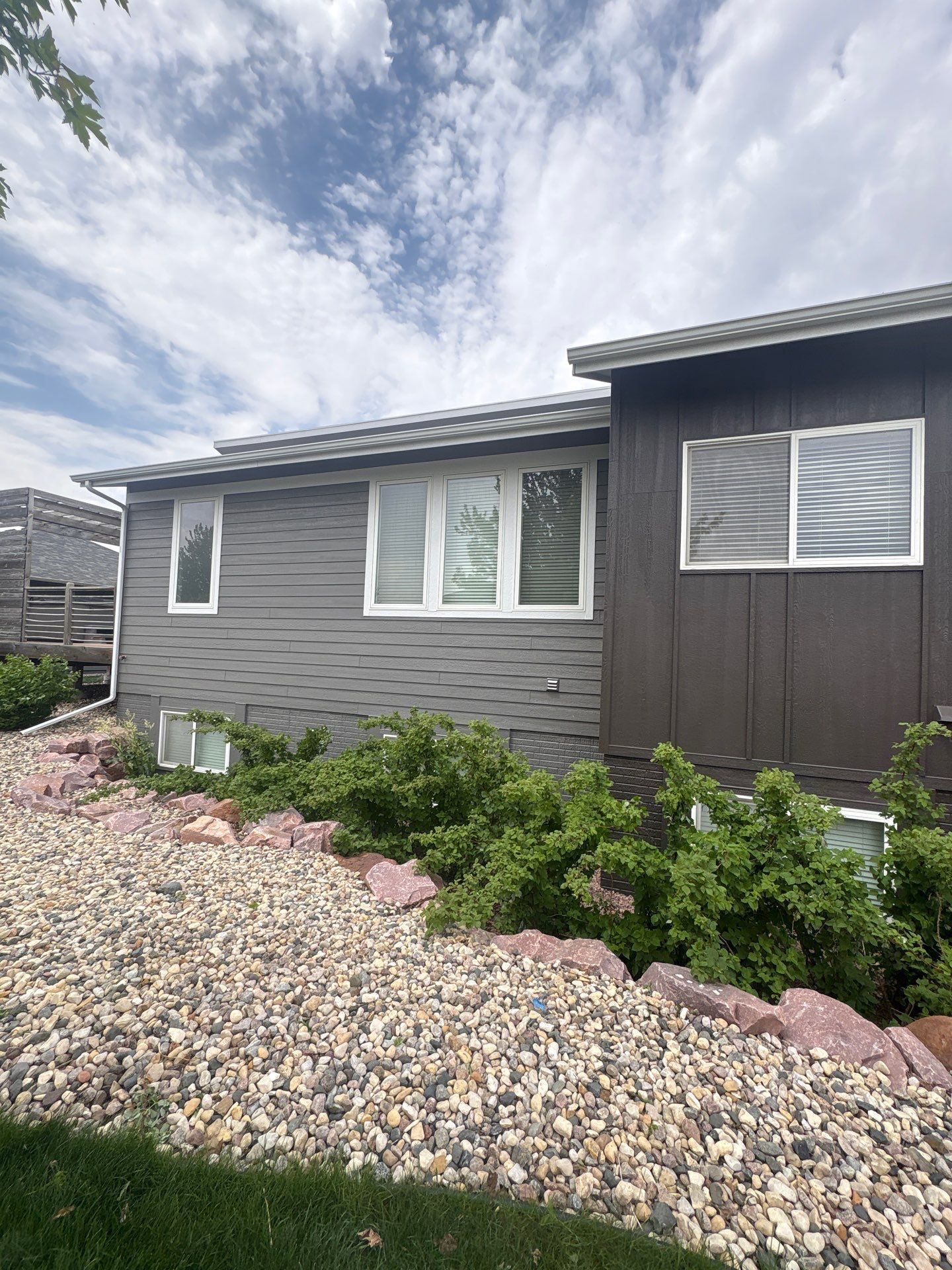 Modern Exterior Transformation Featuring Dark Board and Batten Siding in Sioux Falls by Select Painting, Coatings & Garage Cabinets
