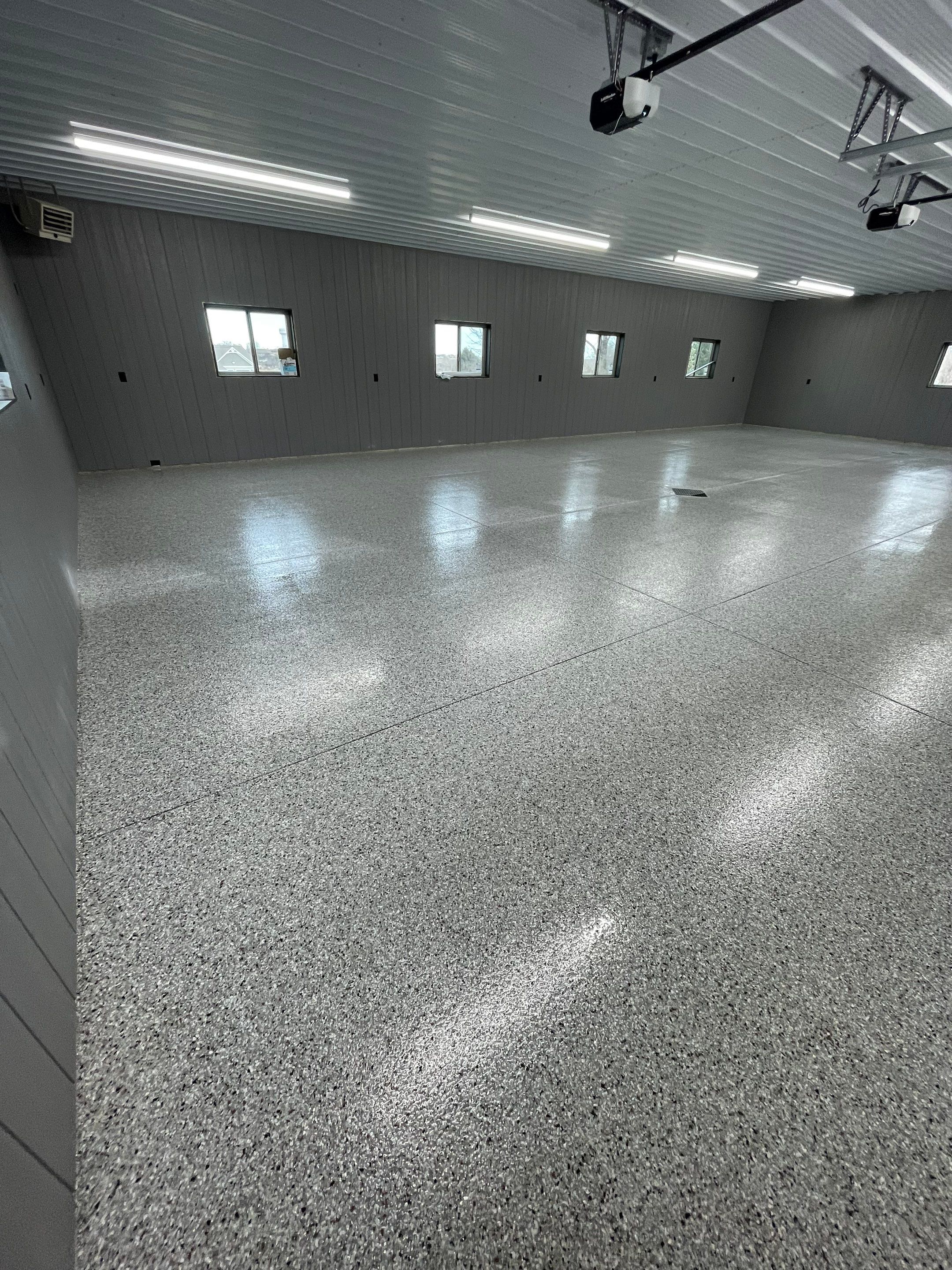 Speckled Epoxy Floor Coating for Large Shop in Rock Valley by Select Painting, Coatings & Garage Cabinets