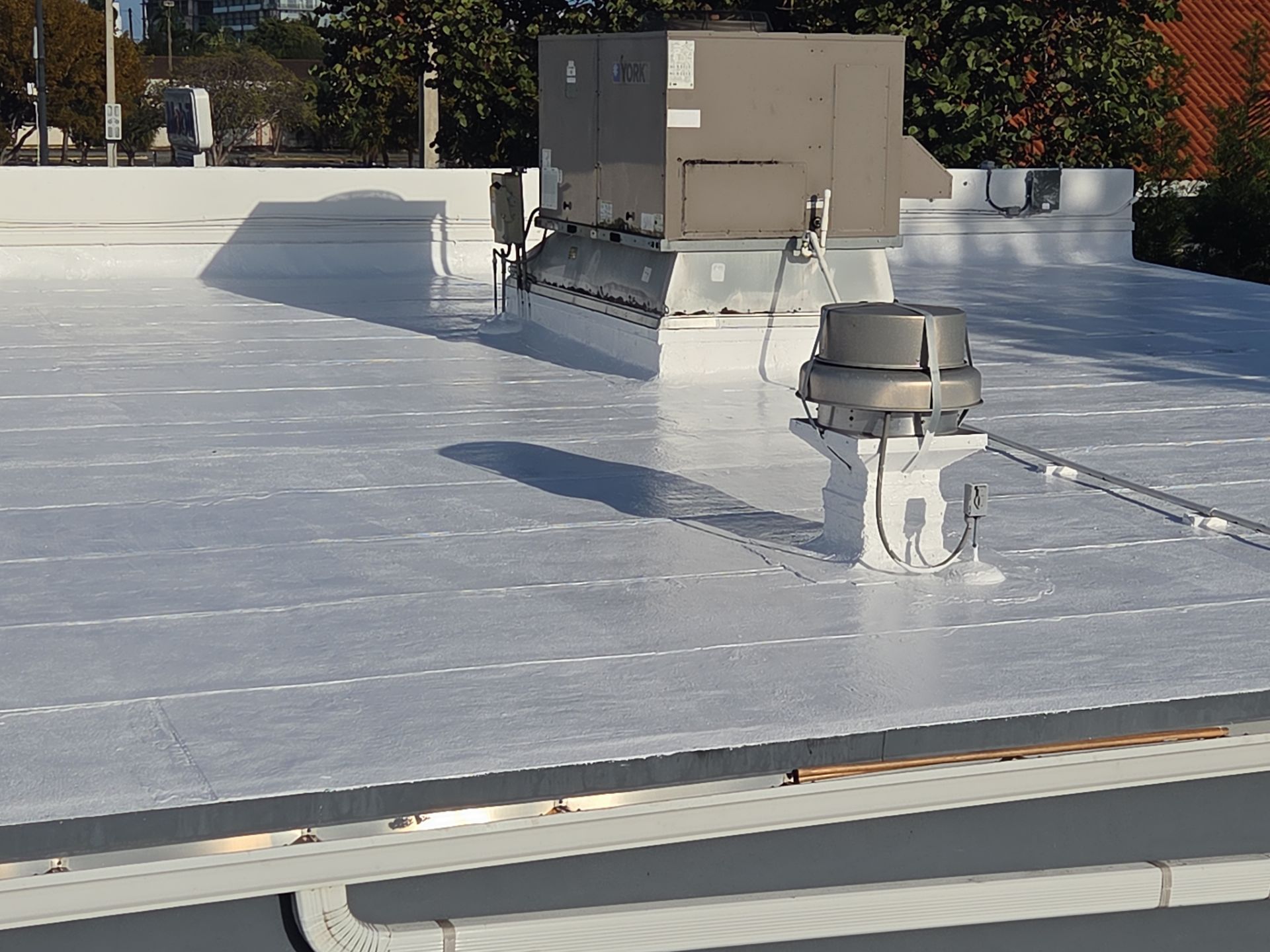 Commercial Flat Roof Restoration Using Silicone Coating in Hallandale Beach by Aastro Roofing