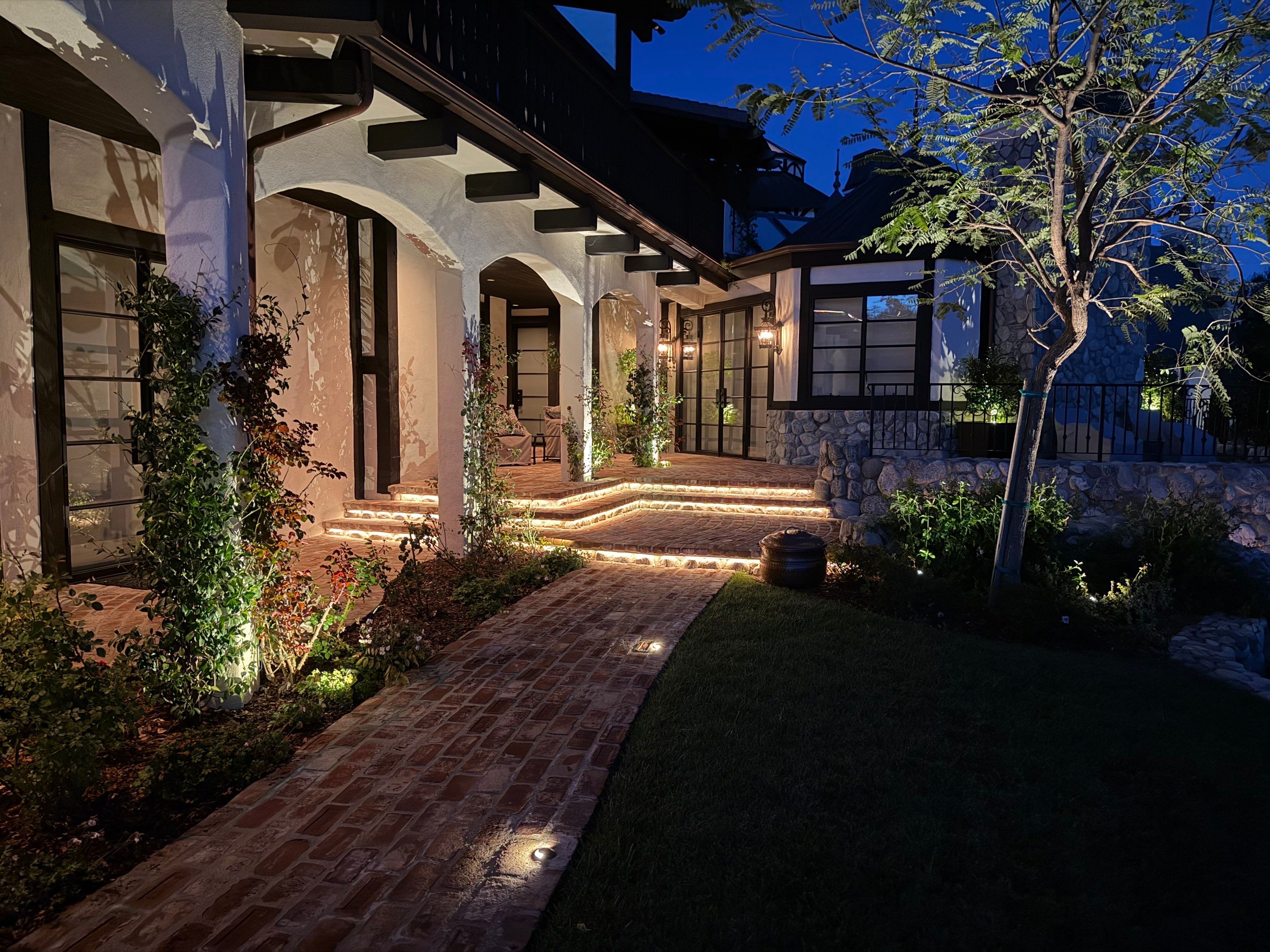 Tudor Estate Landscape Lighting with Integrated Stone Step Illumination by Outdoor Lights + Shades