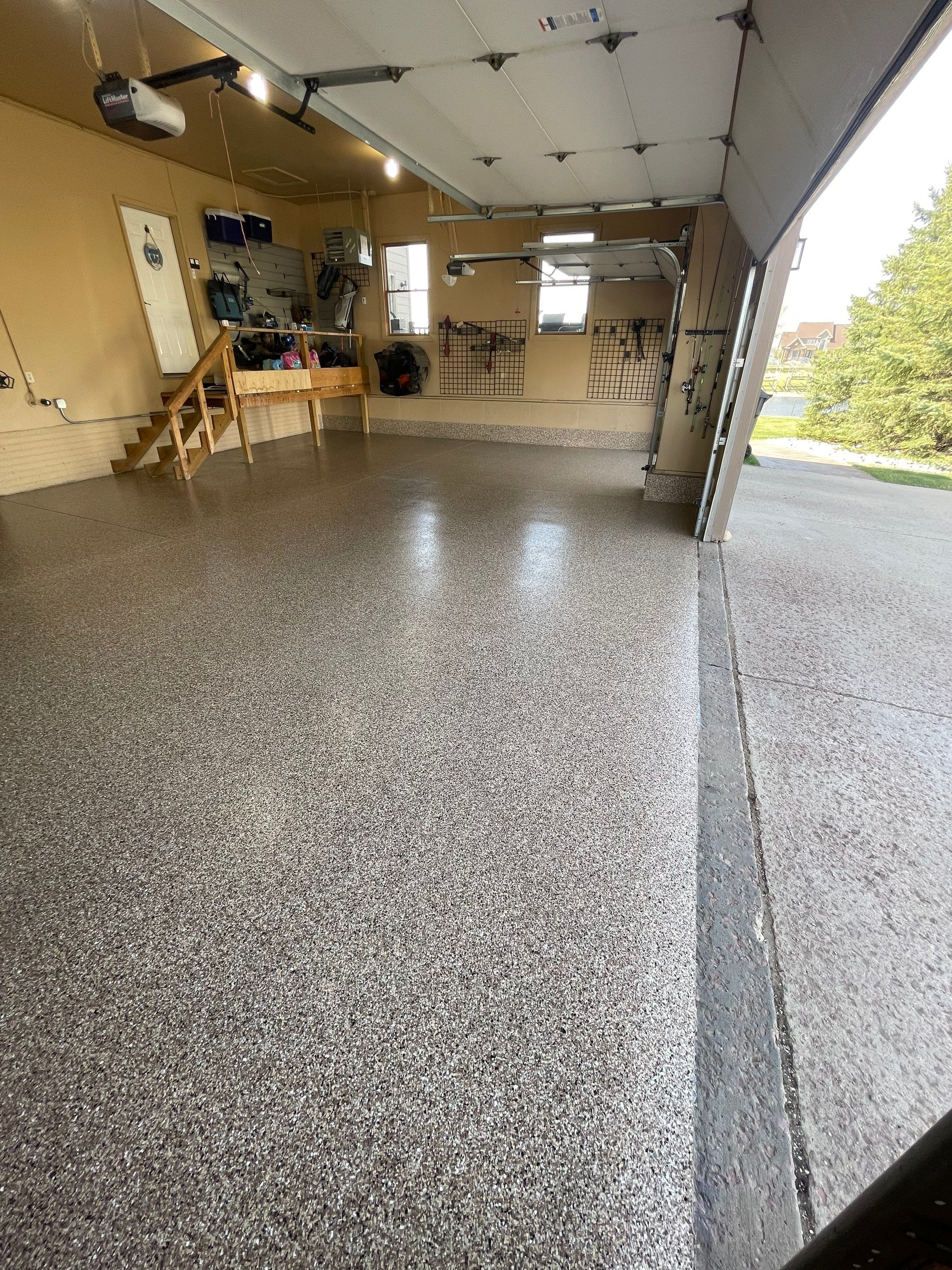 Residential Garage Floor Transformation with Speckled Epoxy Coating by Select Painting, Coatings & Garage Cabinets