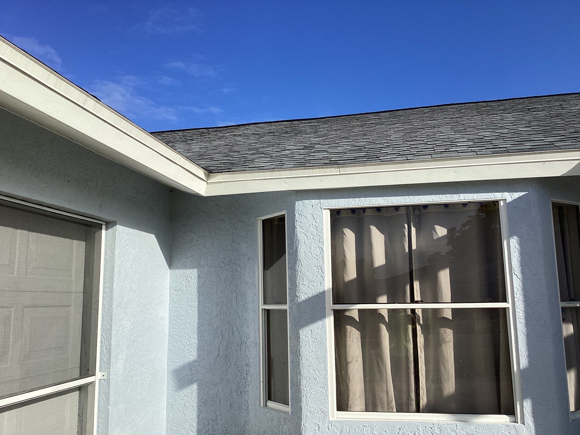 New White Seamless Gutters with Downspouts and Splash Guards in Cape Coral FL by Gutter Professors