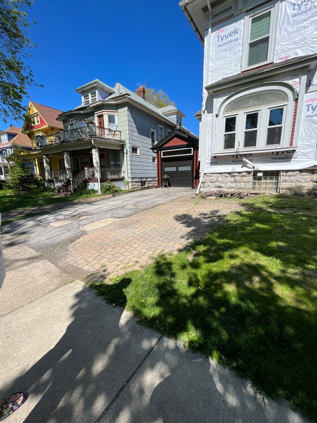 Exterior Renovations- Siding, Stamped Concrete, Porch, and Railings by Ivy Lea Construction