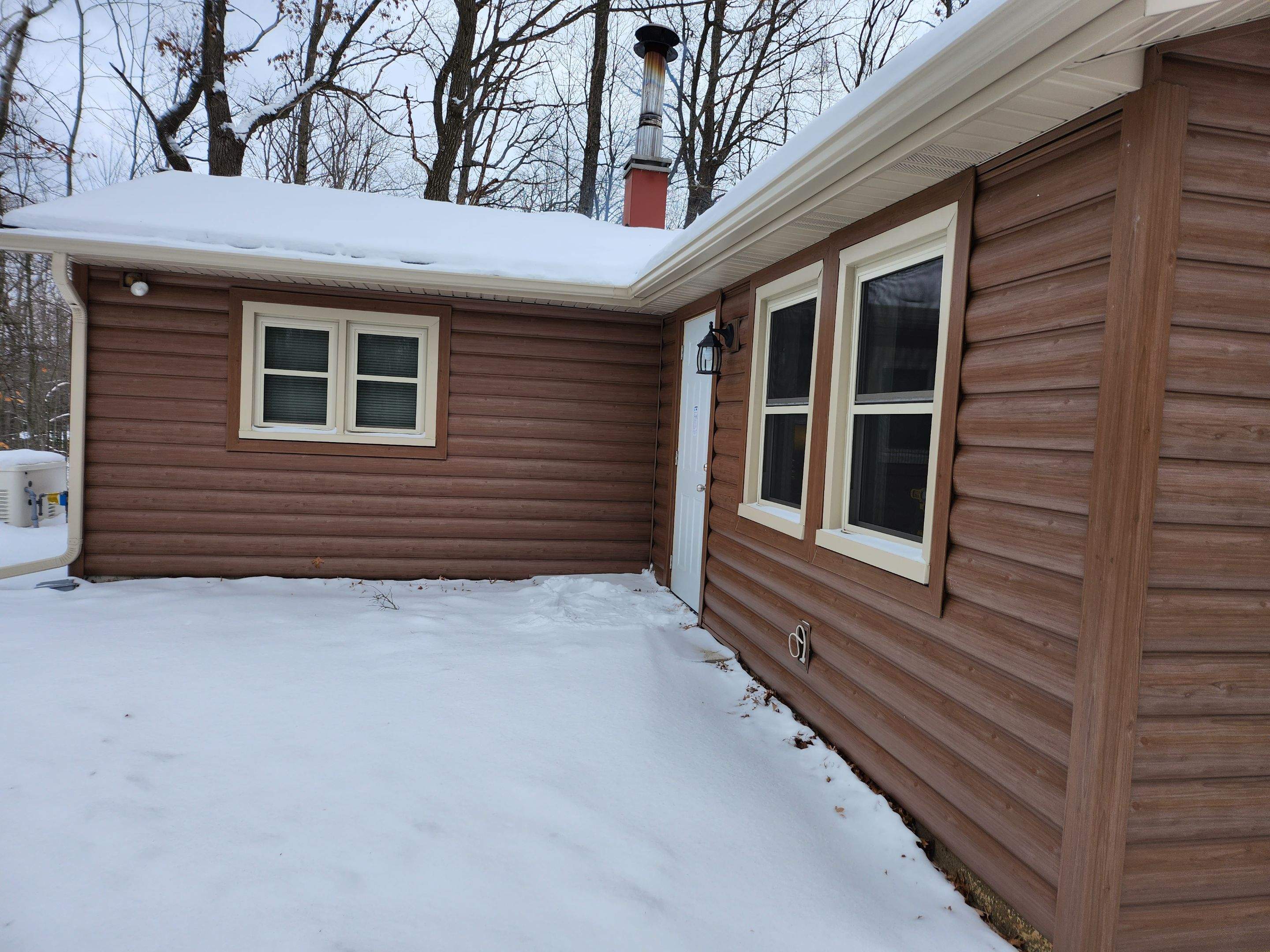 New addition and log siding by Energy Plus Home Improvements