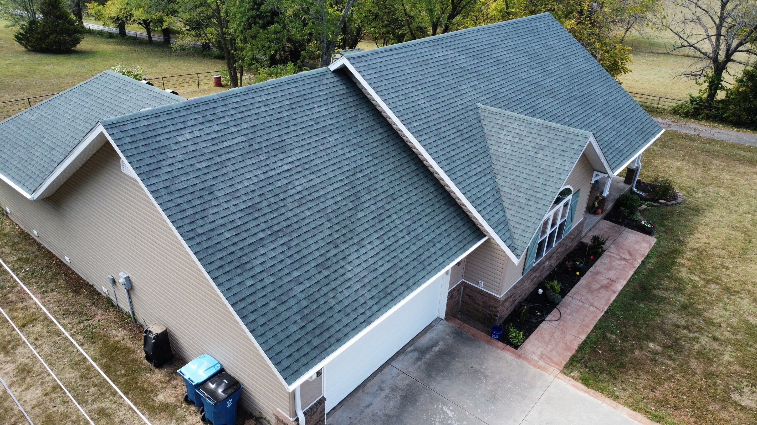 Residential Roofing Install - Green Atlas Pinnacle Pristine Shingles - White Gutters & Downspouts  by Titan Commercial & Residential Roofing 