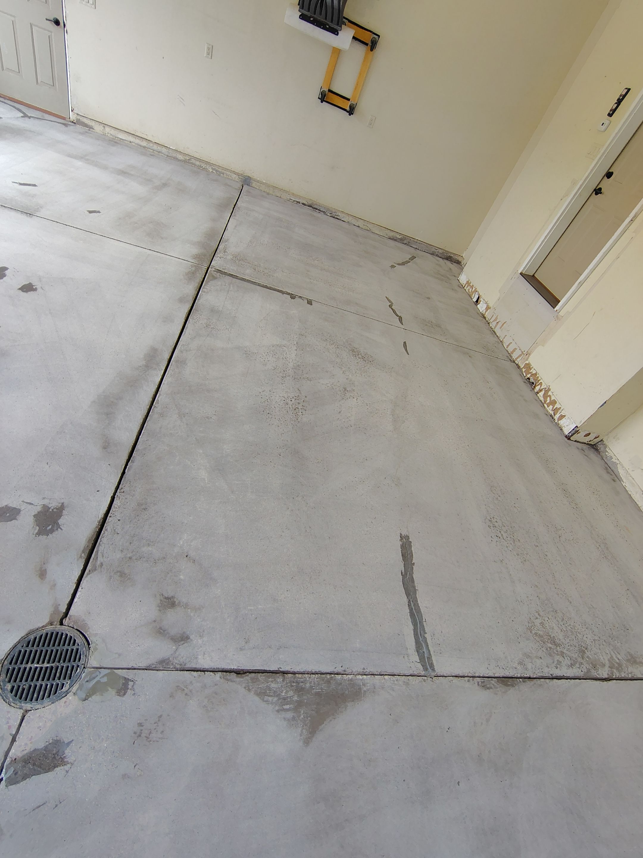 Sioux Falls Garage Floor Repair and Speckled Epoxy Coating Installation by Select Painting, Coatings & Garage Cabinets