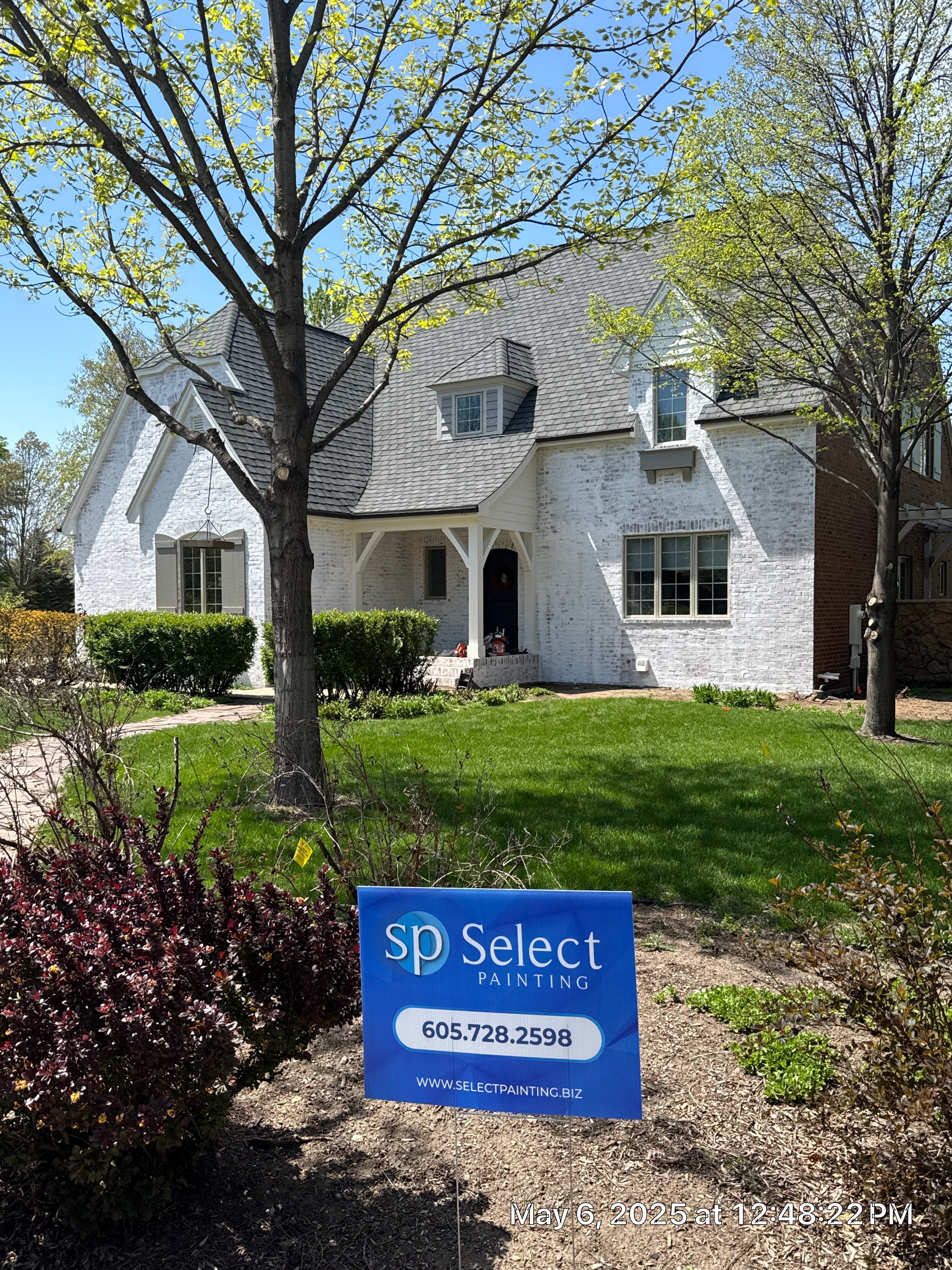 Residential Exterior Brick Painting and Limewash Refresh in Sioux Falls by Select Painting, Coatings & Garage Cabinets
