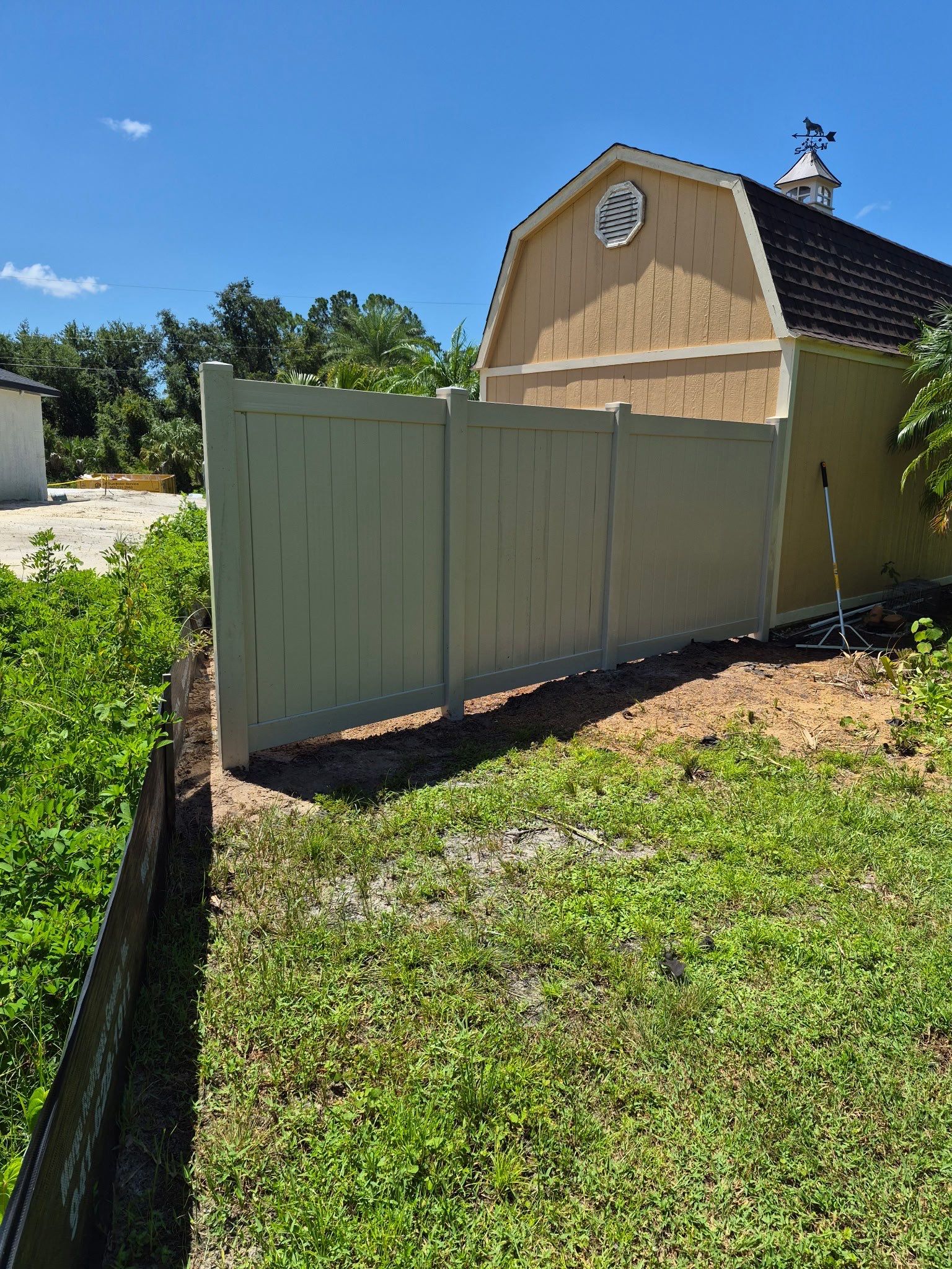 Tan Vinyl Privacy Fence Enclosure Installation in North Port by True Fence LLC