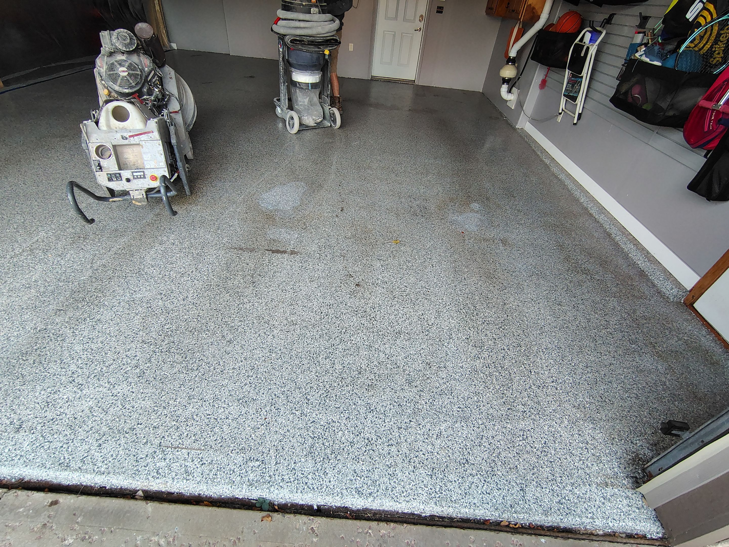 Grey Flecked Epoxy Garage Floor Installation in Sioux Falls by Select Painting, Coatings & Garage Cabinets