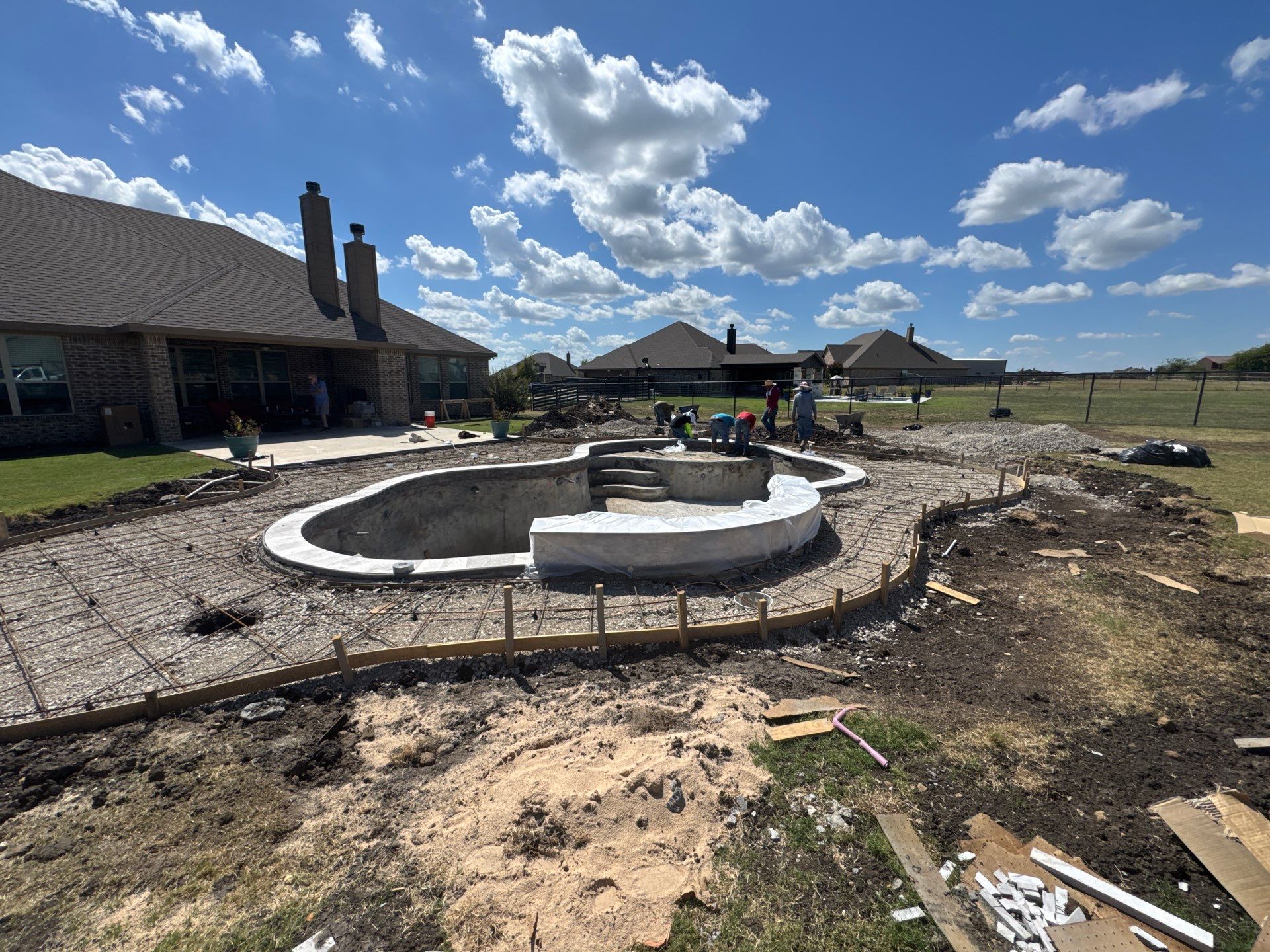 Freeform Pool with Expansive Concrete Deck by Pinnacle Pools and Spas - DFW
