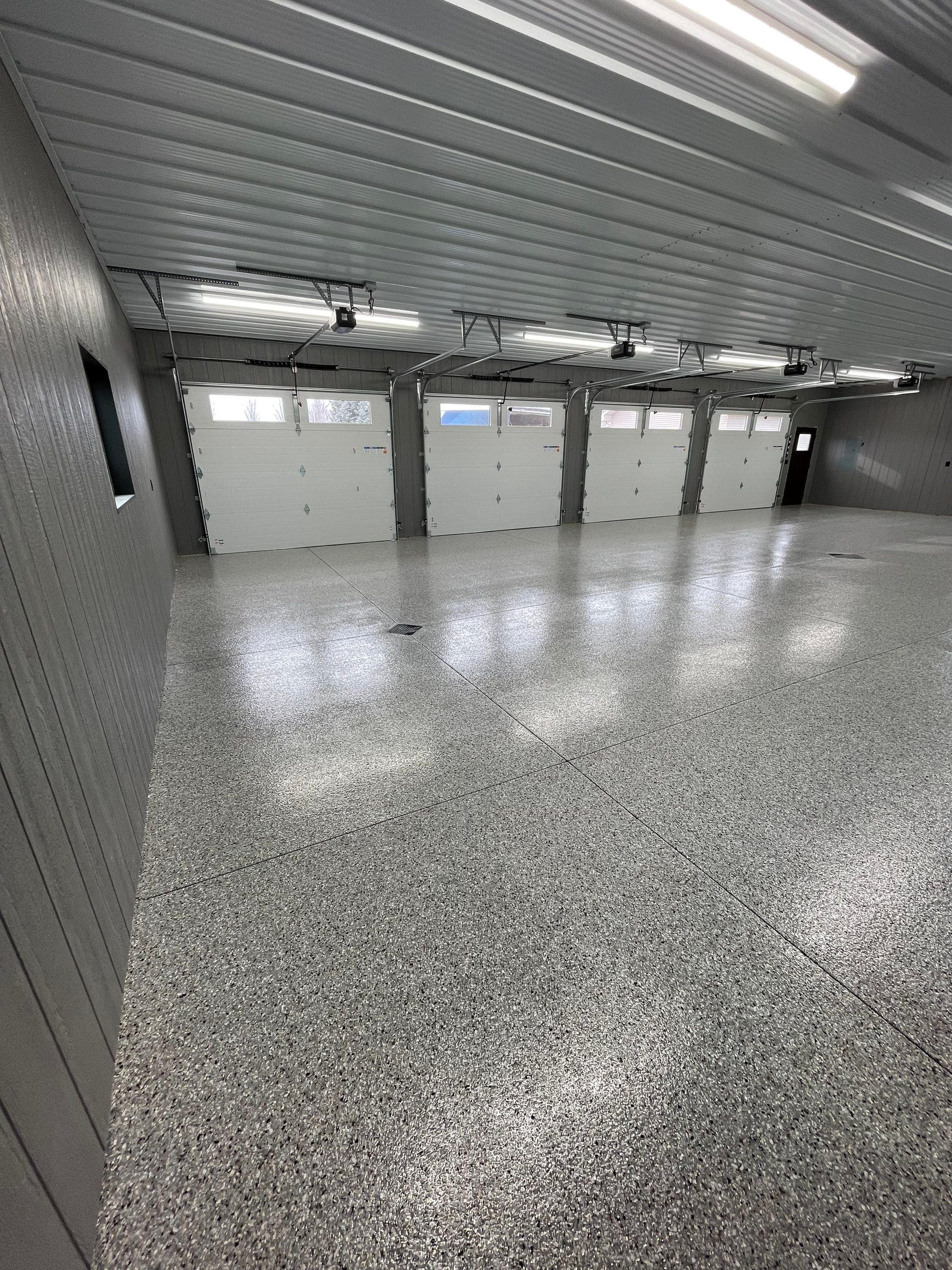 Speckled Epoxy Floor Coating for Large Shop in Rock Valley by Select Painting, Coatings & Garage Cabinets