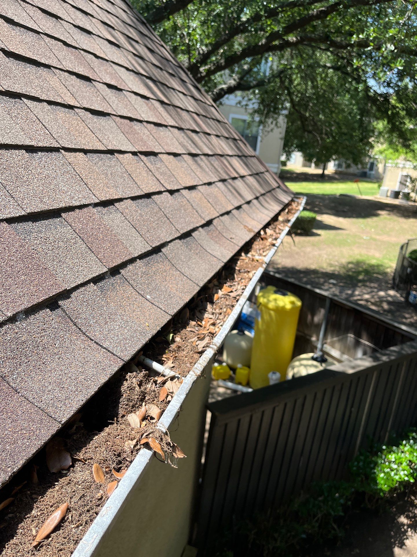 Commercial gutter cleaning Arlington & Grand Prairie, TX before photo with filled gutters