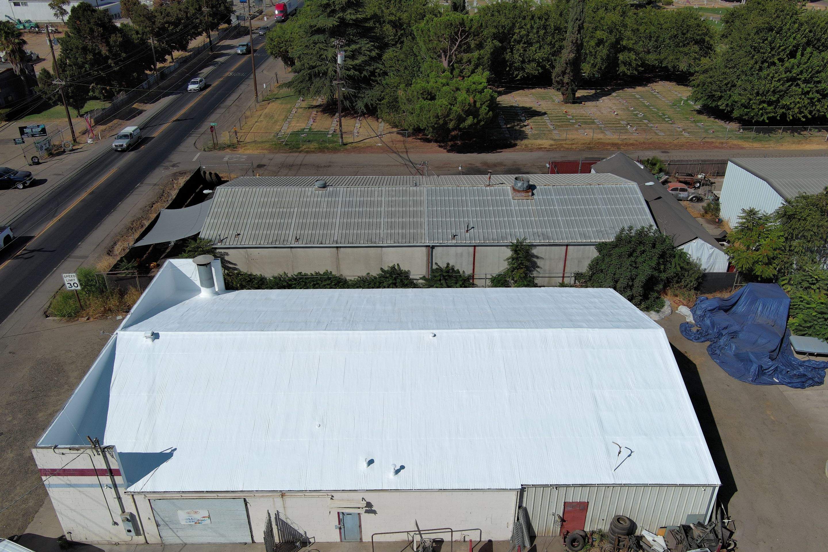 Spray foam and coatings using Conklin Benchmark/ PUMA XL acrylic coatings over metal and foam by Straight Edge Roofing Inc