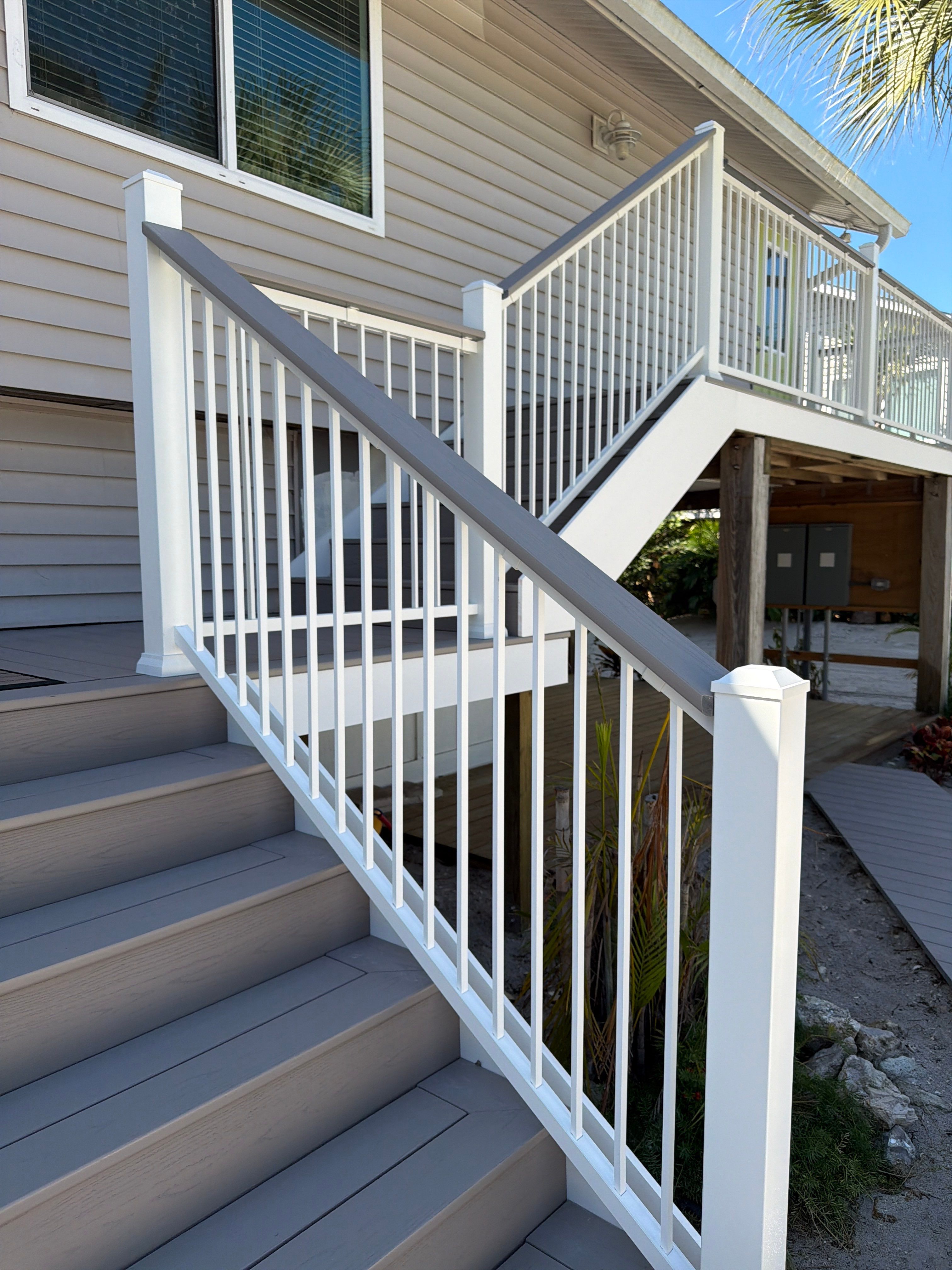 Elevated Home Deck Reconstruction With White Aluminum Railings in Placida by Smirnov Construction Inc