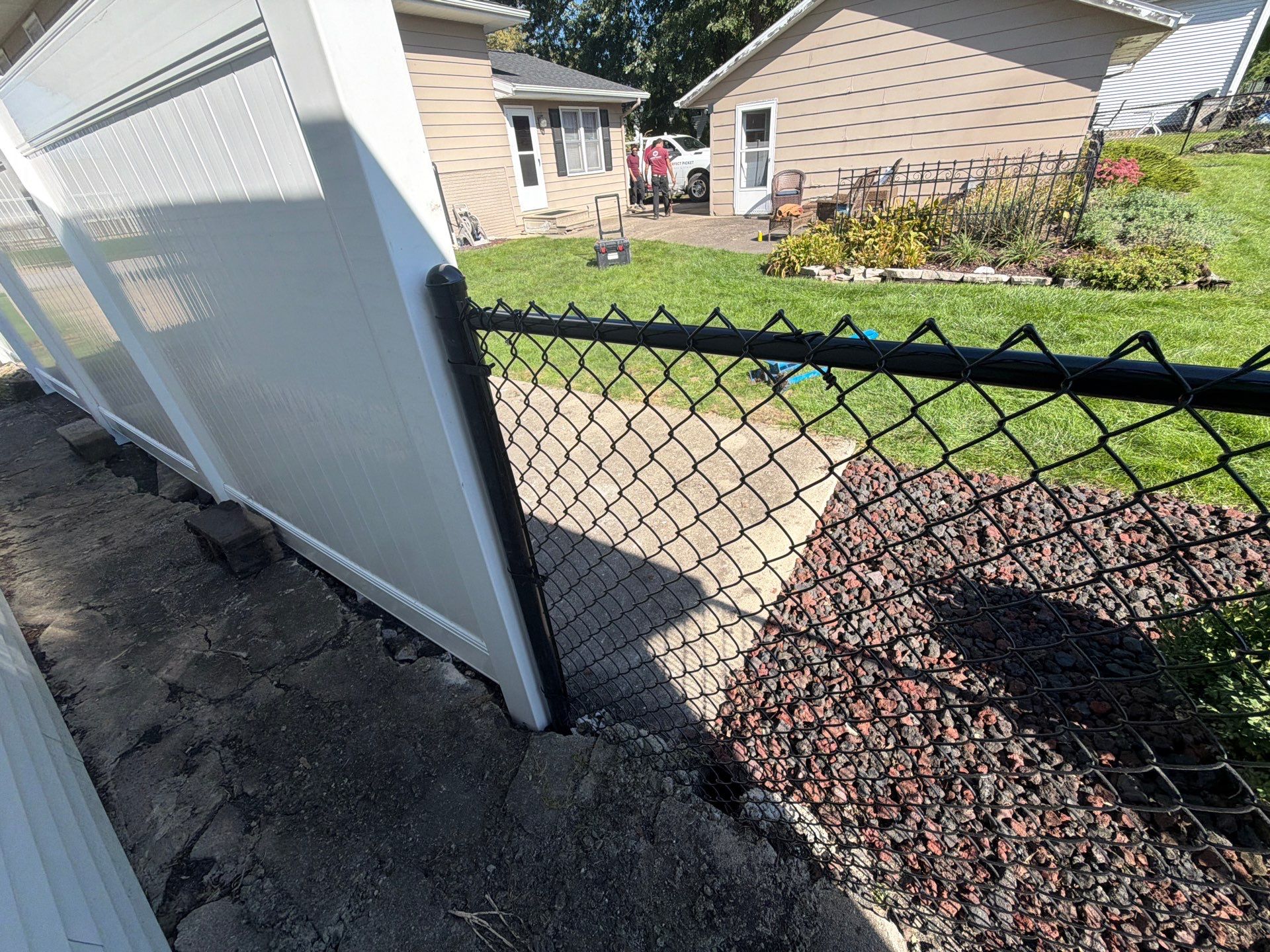Custom Vinyl Privacy and Black Chain Link Fence Installation in Cedar Falls by Perfect Picket Fence and Stain