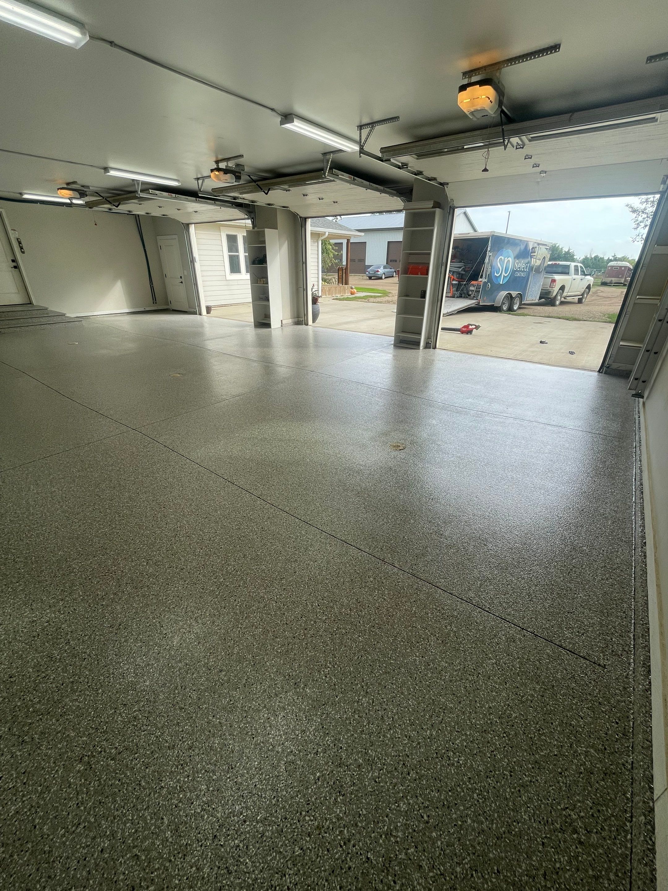 Grey Speckled Polyuera Garage Floor Coating for Hartford Three-Car Garage by Select Painting, Coatings & Garage Cabinets