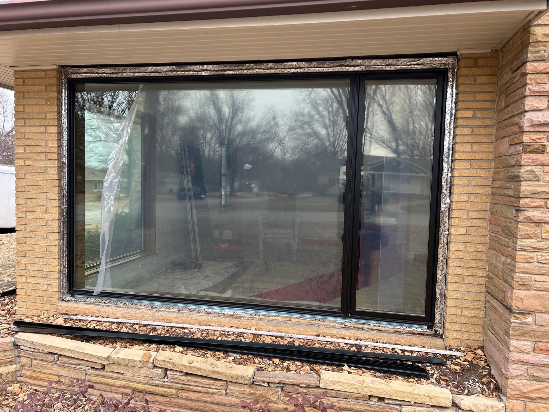 Black-Frame Pella Lifestyle Upgrade on a Partial Brick Home by United Windows and Siding LLC