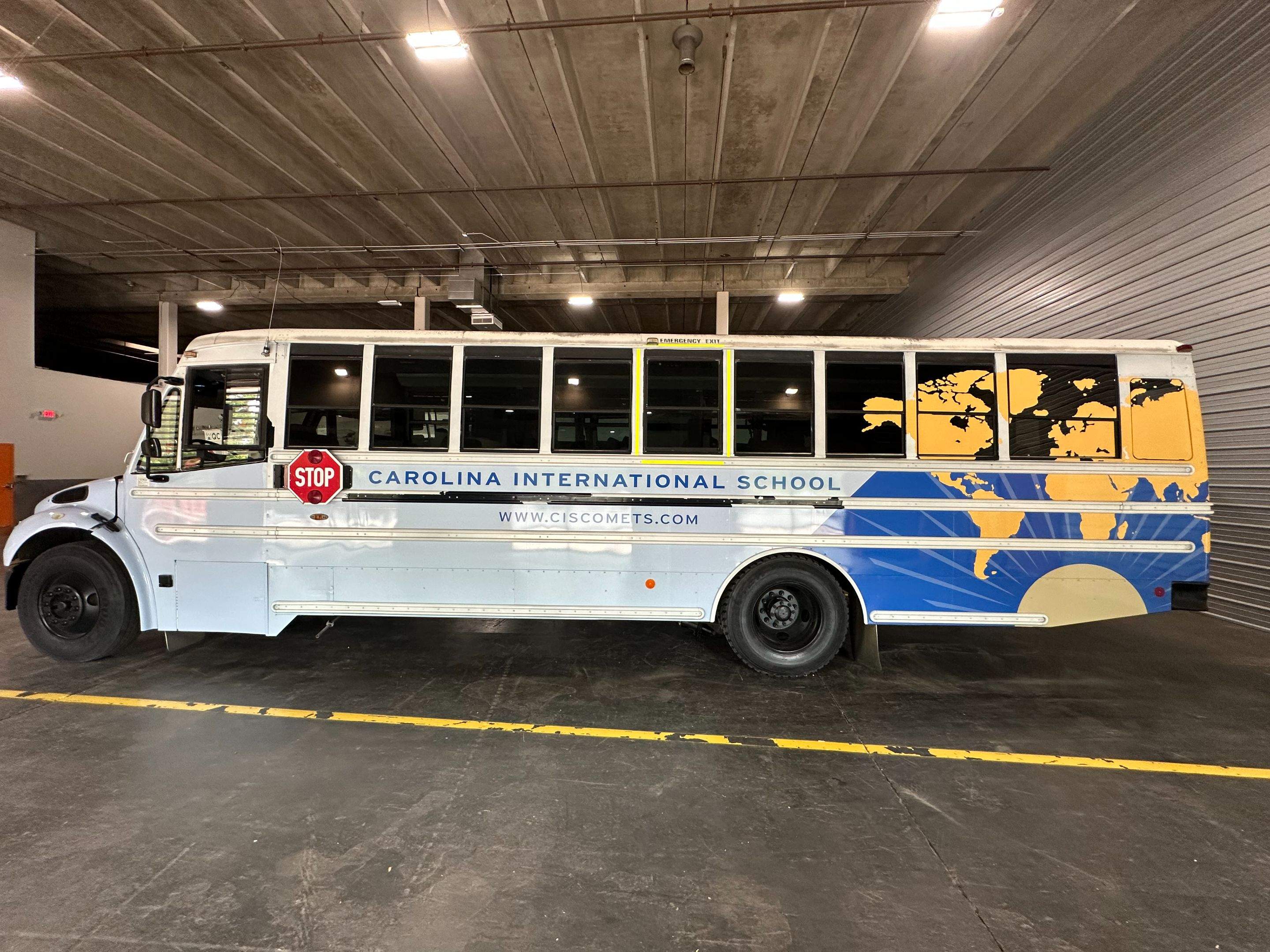 Carolina International School - Bus Vinyl Wrap by QC Signs and Graphics