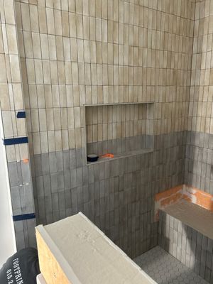 Tile floors, walls, showers, and accent wall for bathrooms