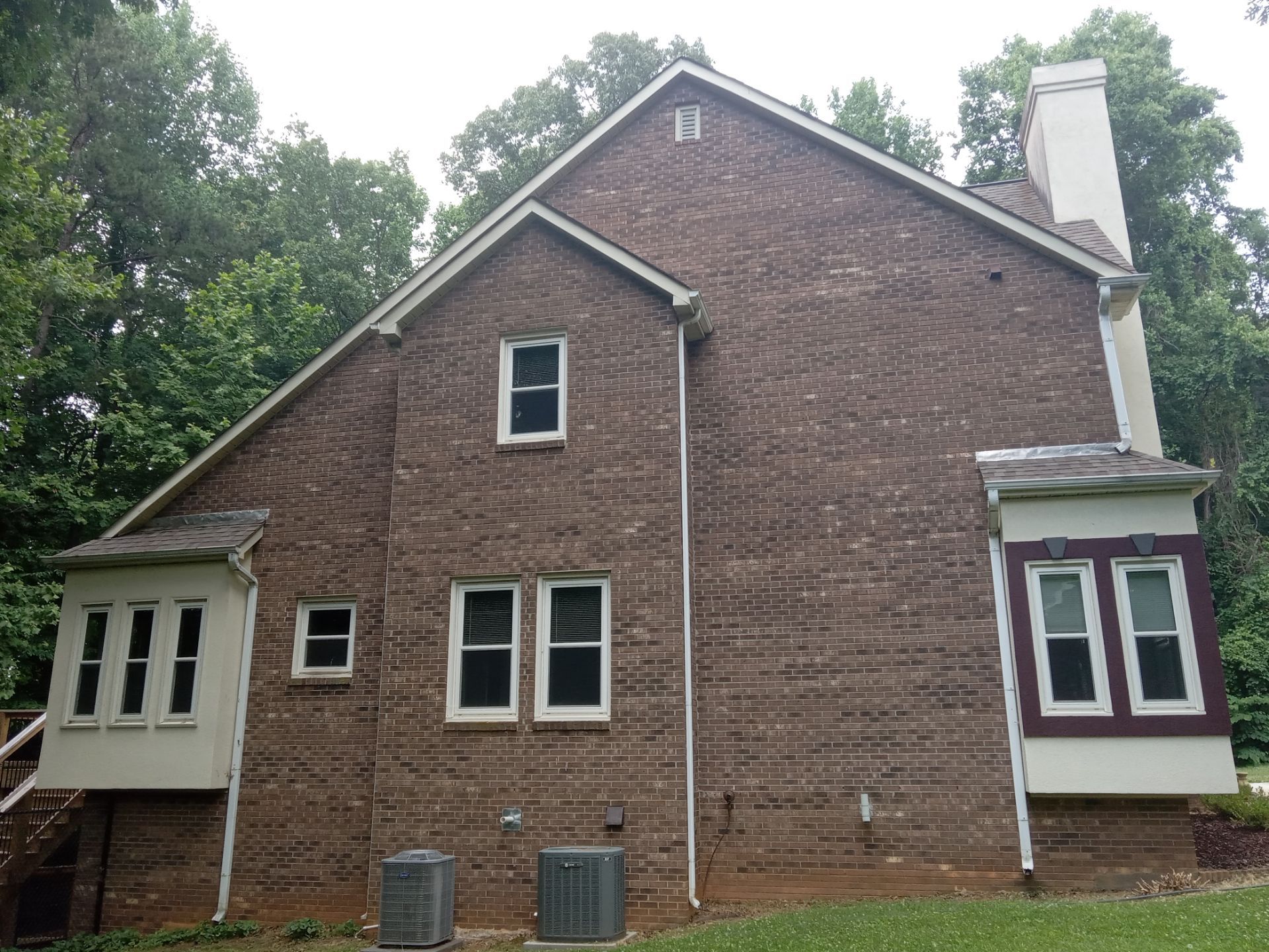 the pressure washing company in kernersville nc is cleaning the exterior brick surface of a house the service includes cleaning dirt mold and mildew from the bricks to restore their appearance the pressure wash can also clean the siding around the windows the gutters and the downspouts to maintain the home's curb appeal the pressure washing technique uses high-pressure water spray to effectively remove grime from various outdoor surfaces including brick, siding, and wood surfaces