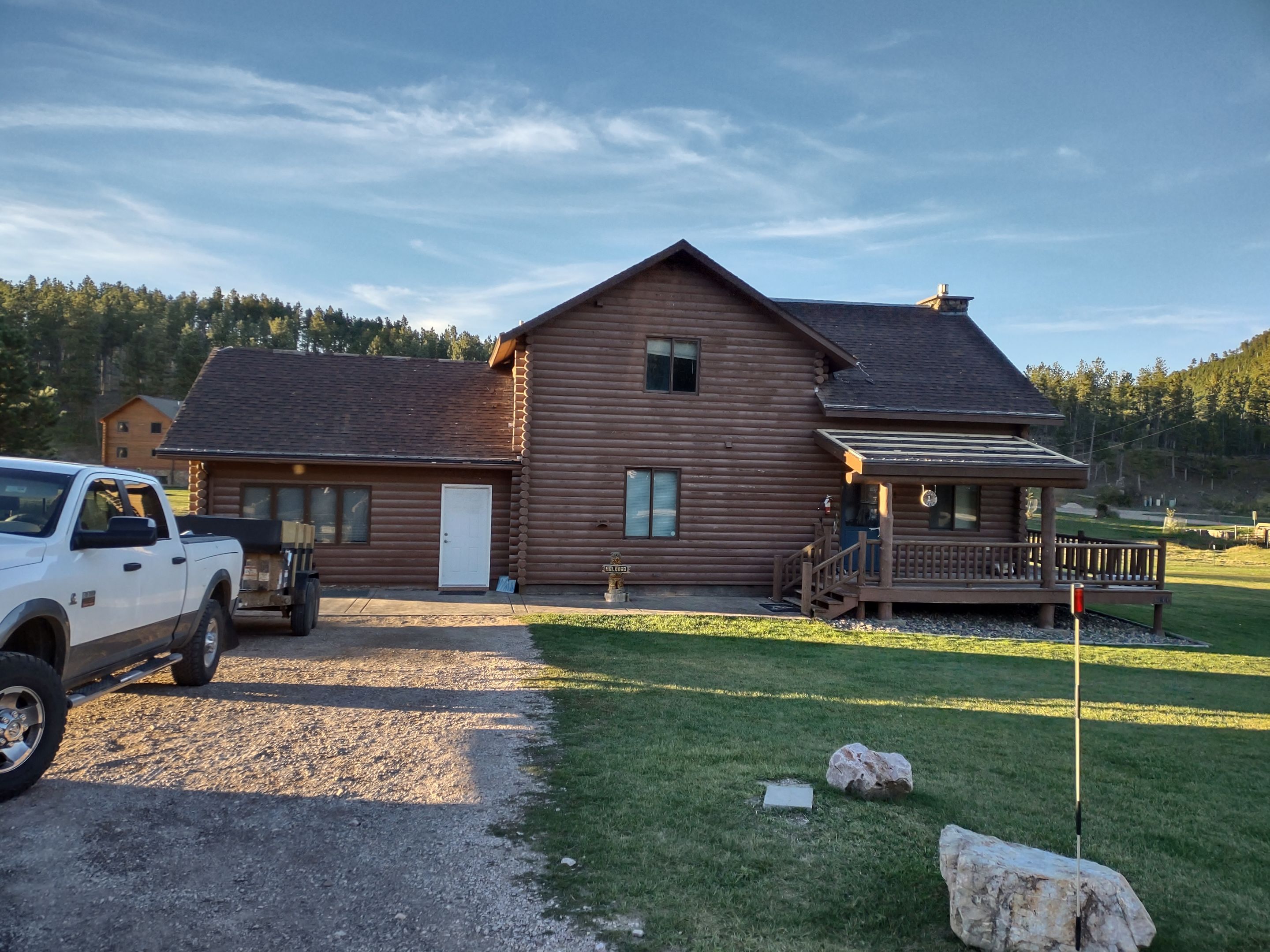 Hill Country Guest Ranch using Steel Roofing, Gutters, Log Cabin Staining by Lightning Exteriors