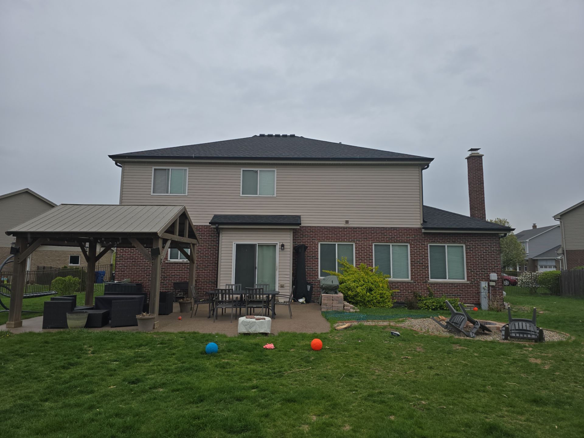 New black gutters and roof by Optimal Home Improvement 