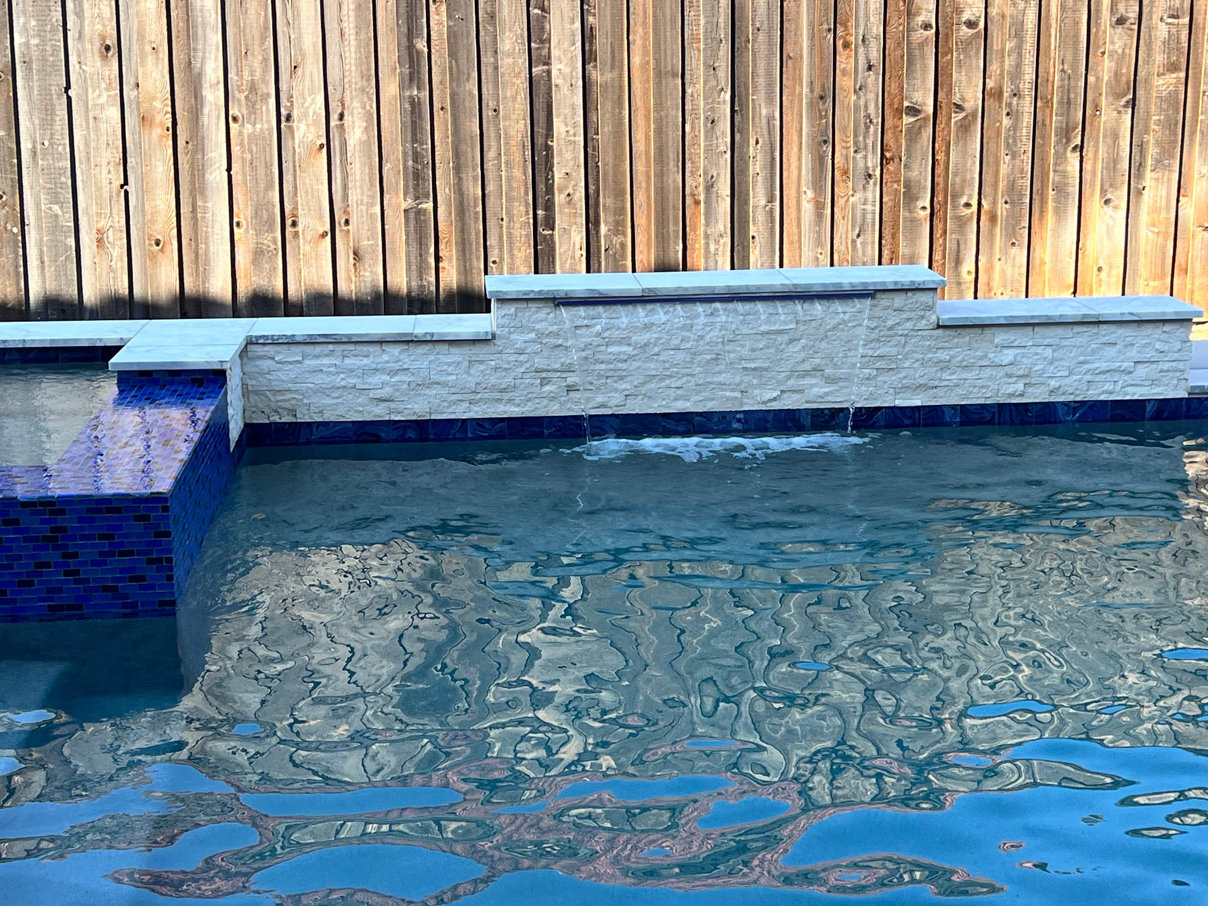 Geometric Pool with Raised Spa and Blue Glass Tile by Pinnacle Pools and Spas - DFW