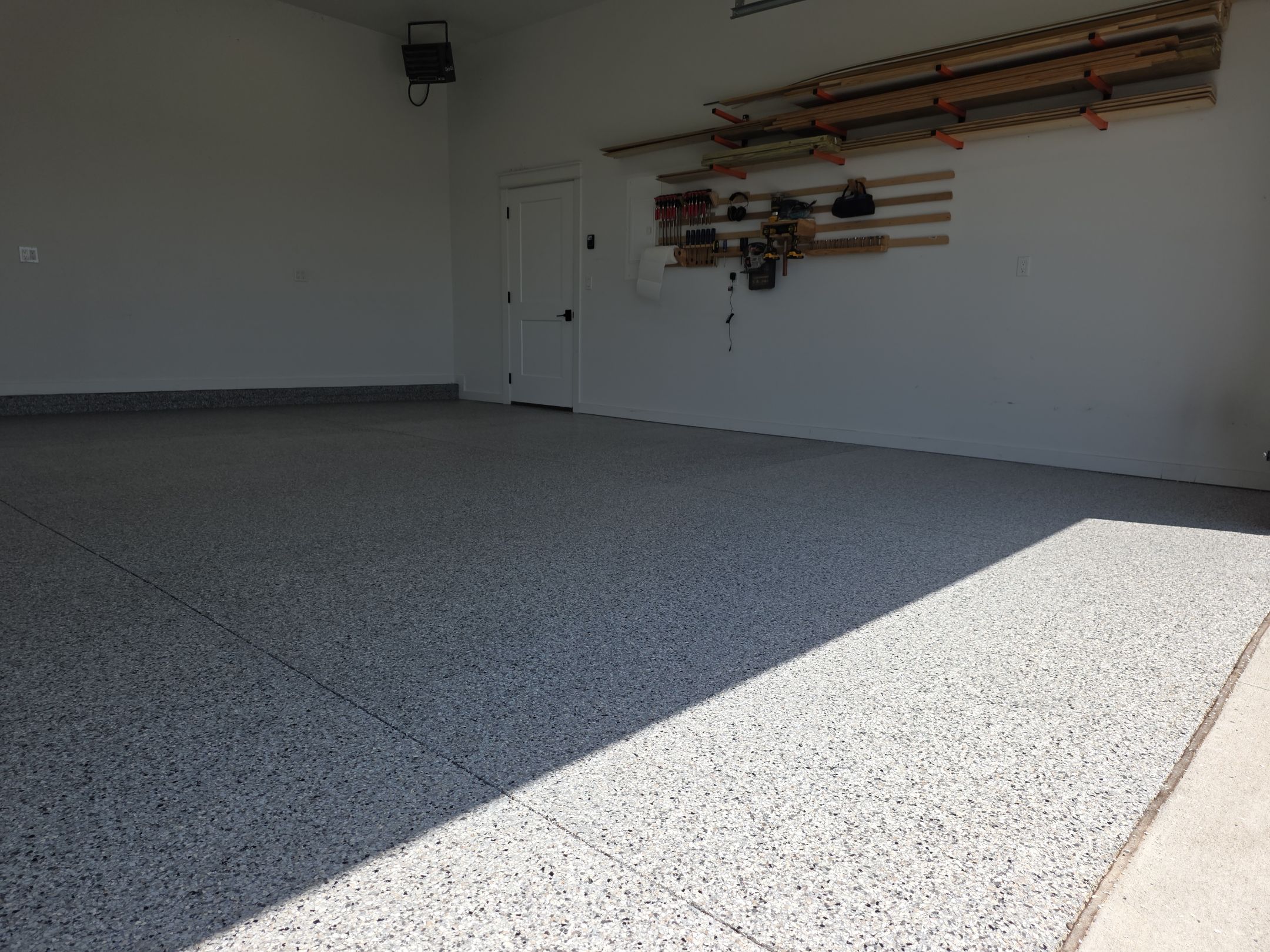 Ames Garage Floor Transformation with Gray and White Speckled Epoxy by Revival Concrete Coatings