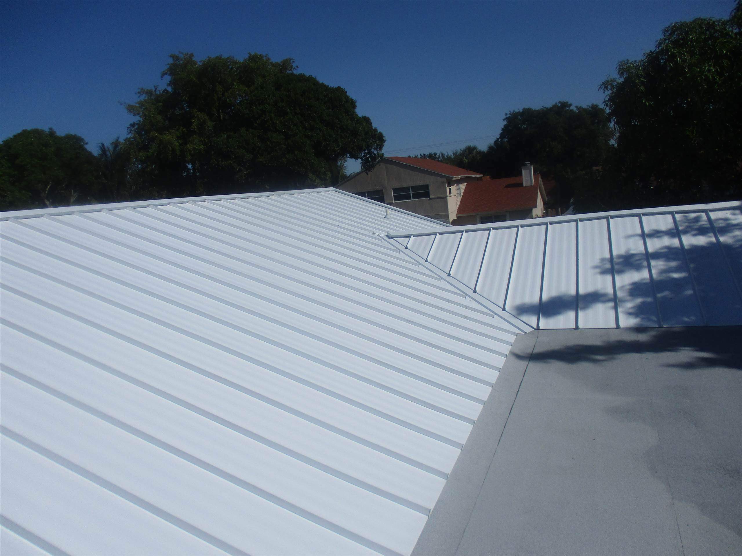 Standing Seam Metal & Flat Re-Roof using 1.5" Nail Strip 24ga Solar White Kynar Coated Standing Seam Metal Panels by Morton Roofing, Inc.