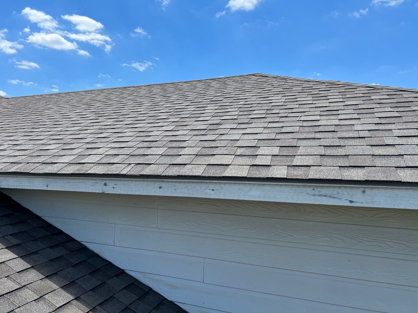 Wind damaged roof replacement by Oakwood Roofing and Construction, LLC