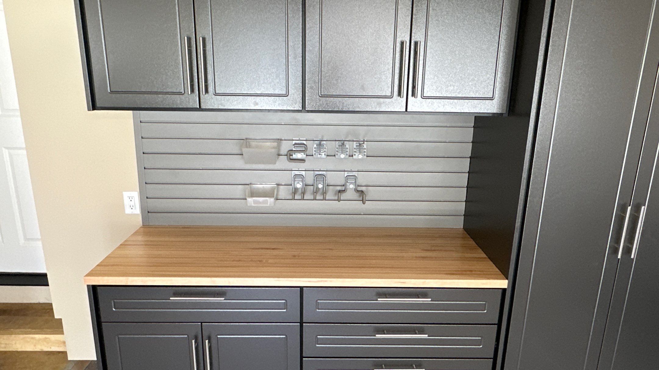 Trevor F. got a workbench with his garage cabinets.  by Banner Garage