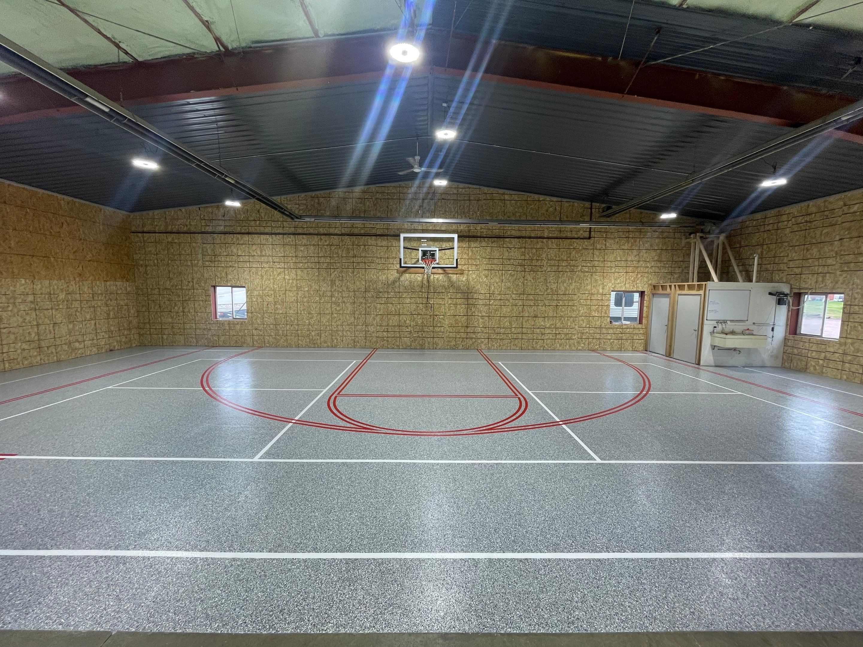Custom Polyurea Shop Floor with Basketball Court Lines in Rock Valley by Select Painting, Coatings & Garage Cabinets