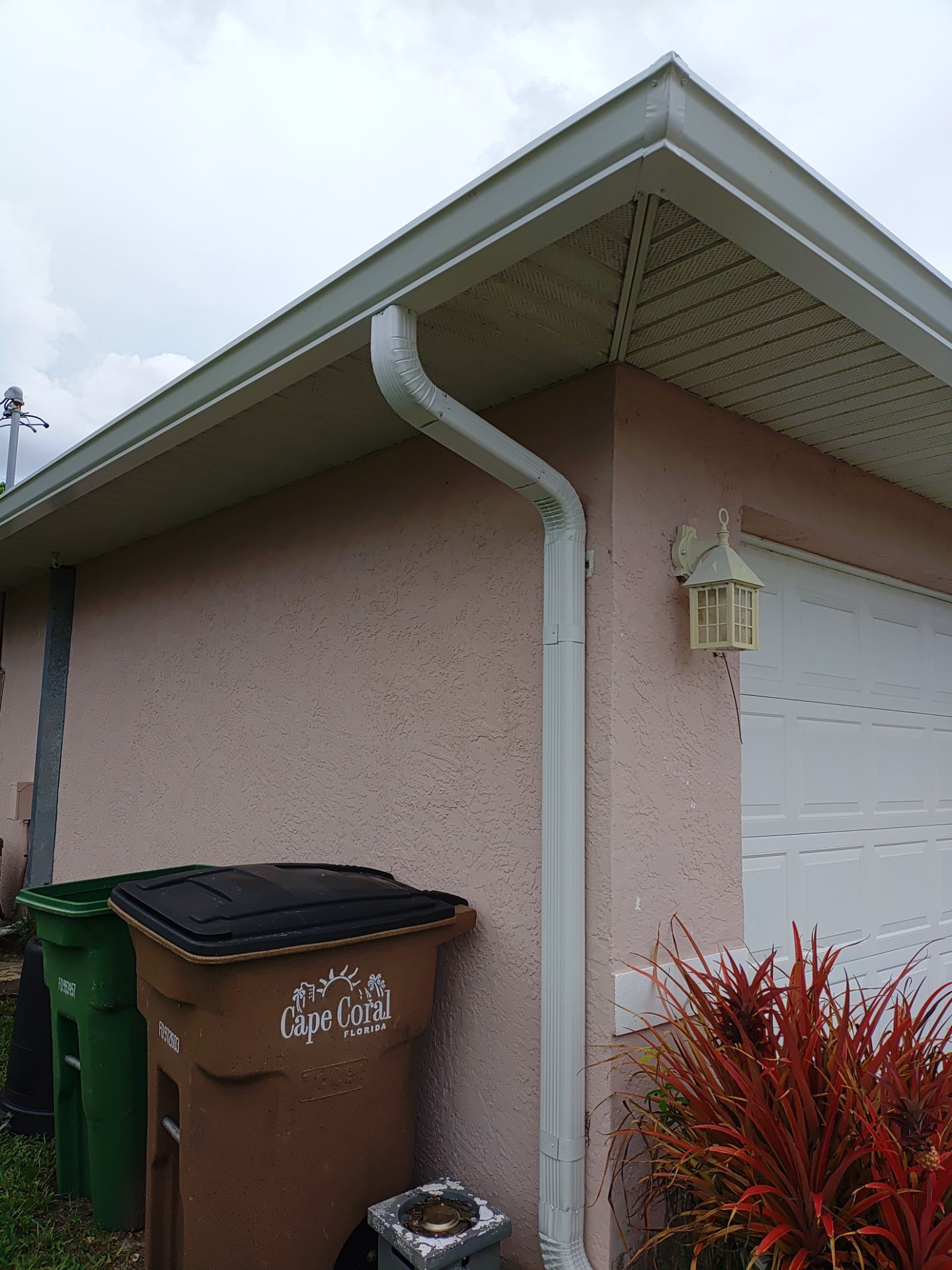 Replace gutter using White Down Spouts in Cape Coral FL by Gutter Professors